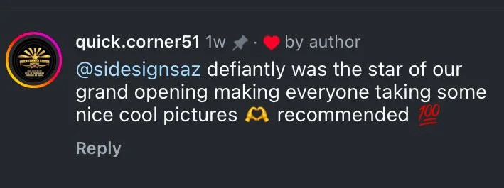 Screenshot of a social media comment praising someone's photogenic appearance at a grand opening event, with emojis including a hug and a hundred points.
