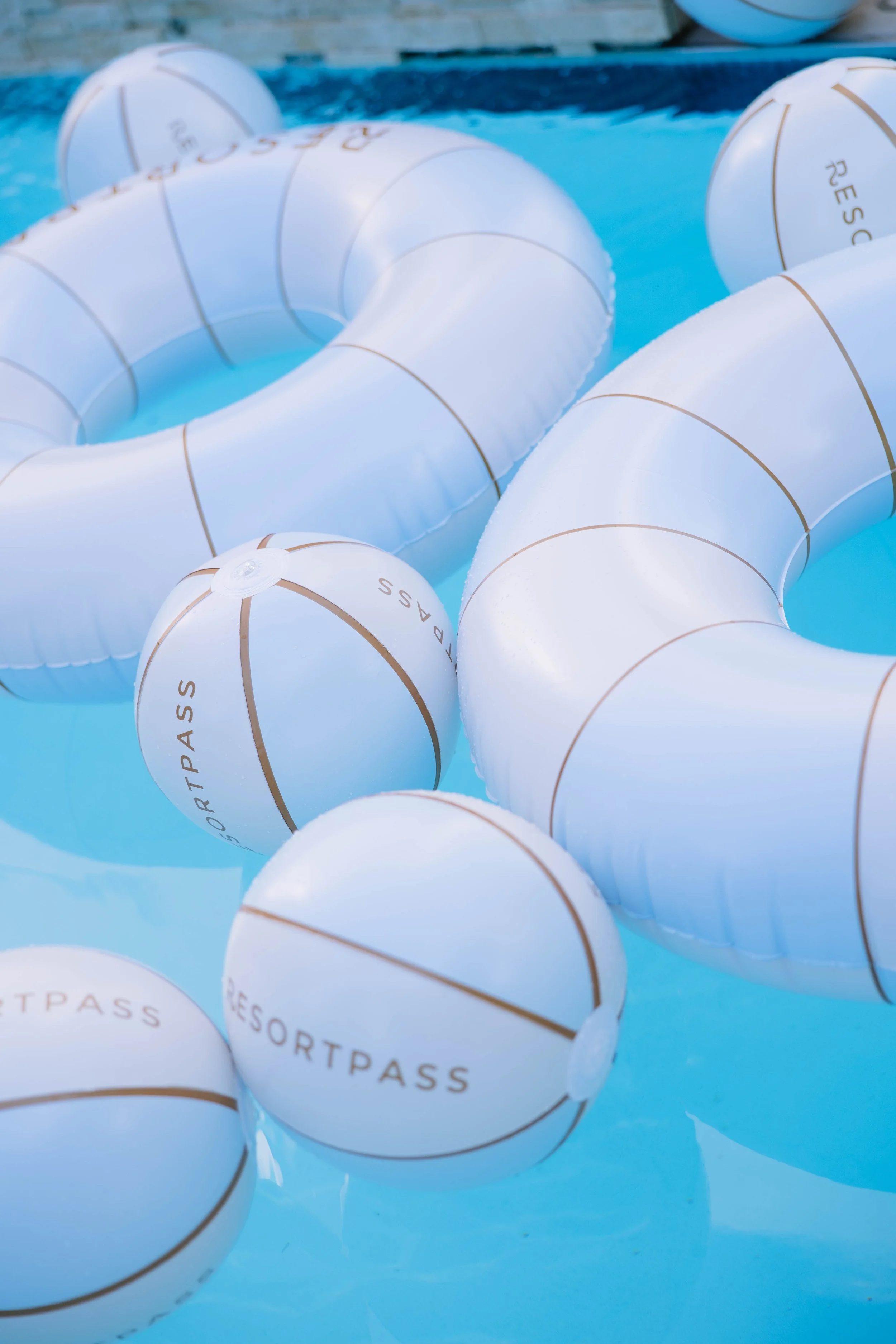 Custom ResortPass floats in a bright blue pool in Florida