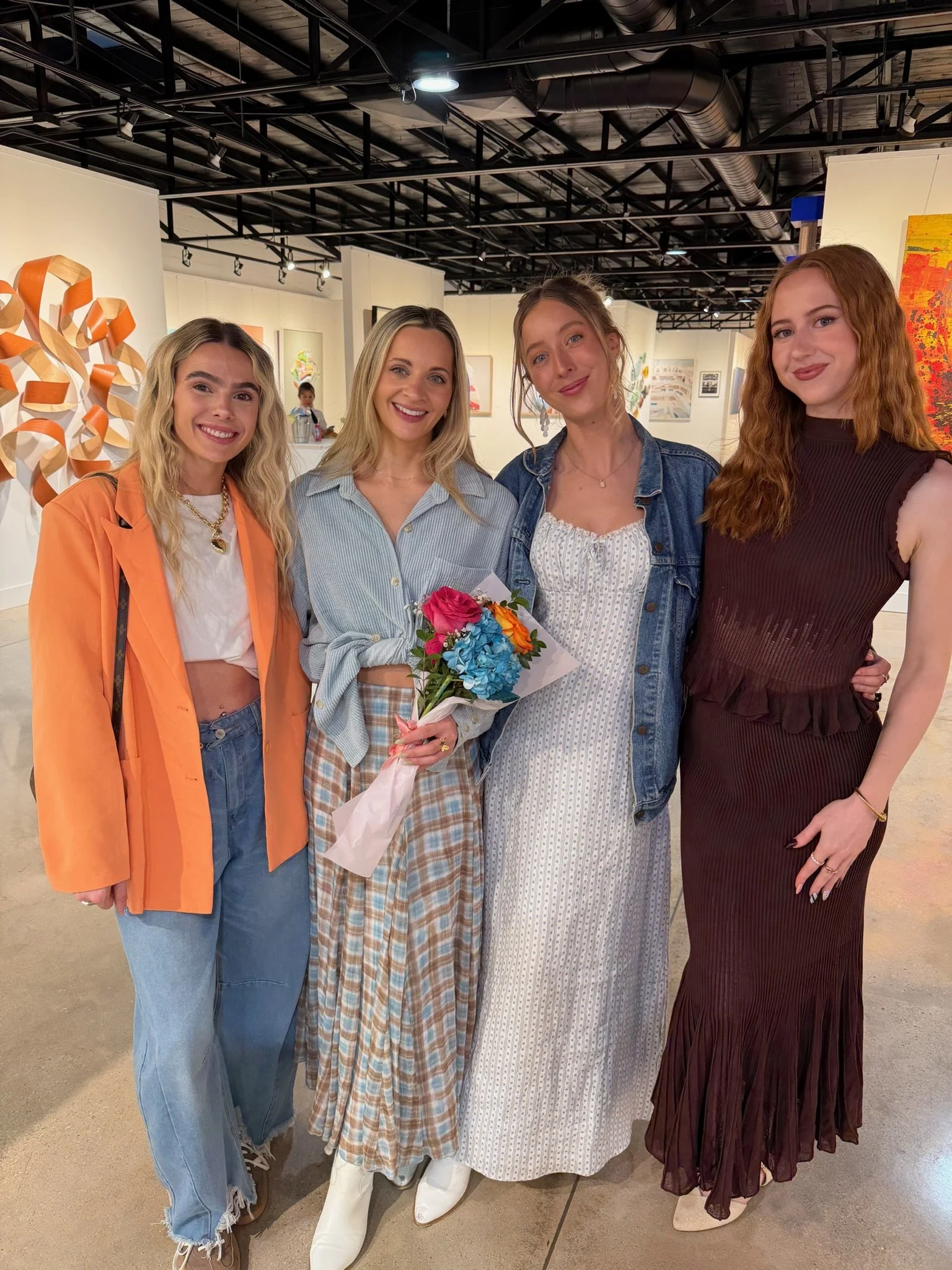 Group of girls at avenue 8. One is holding a bouquet of flowers.