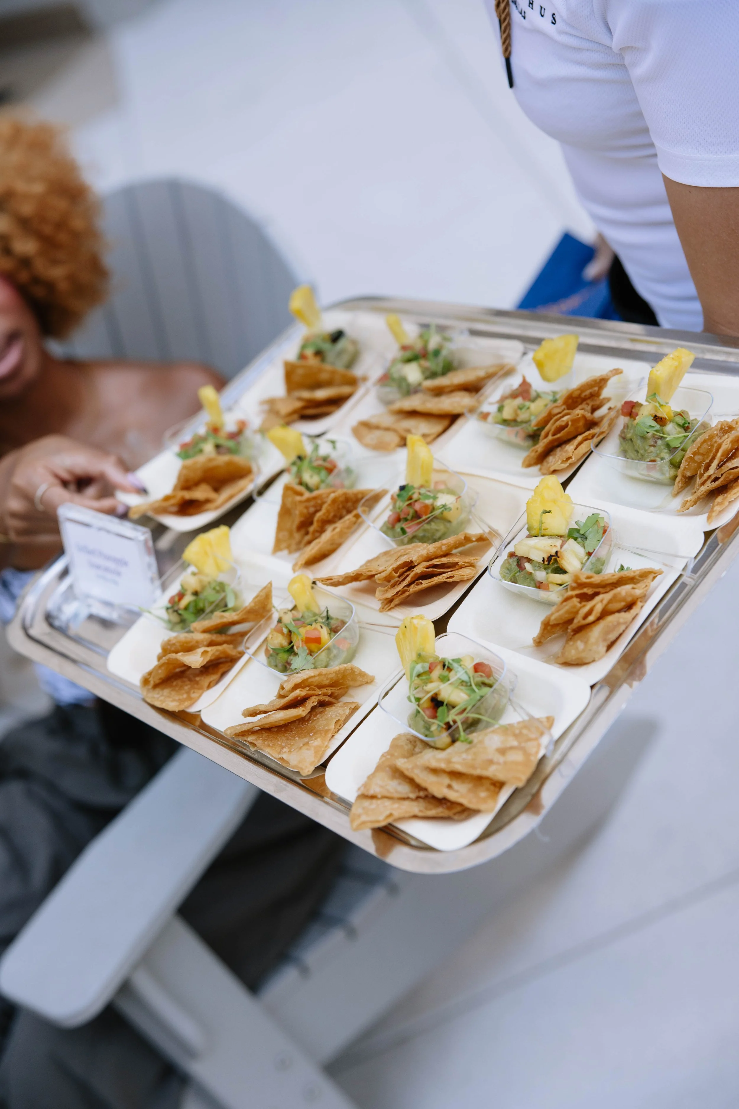 fresh tortilla chips on a small cup with guacamole.