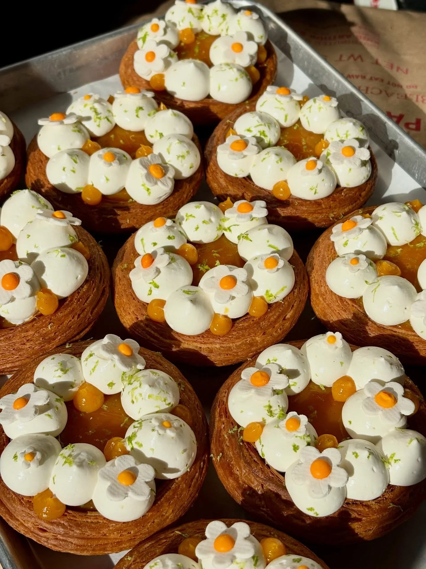 EASTER SPECIAL PART 4: MANGO LASSI CROISSANT 🥭

Tangy labneh cheesecake and sweet mango gelee combine for this refreshing not-too-sweet croissant special. Topped off with handmade (!!!) candy daisies because SPRING. 

On the counter in GREENPOINT to