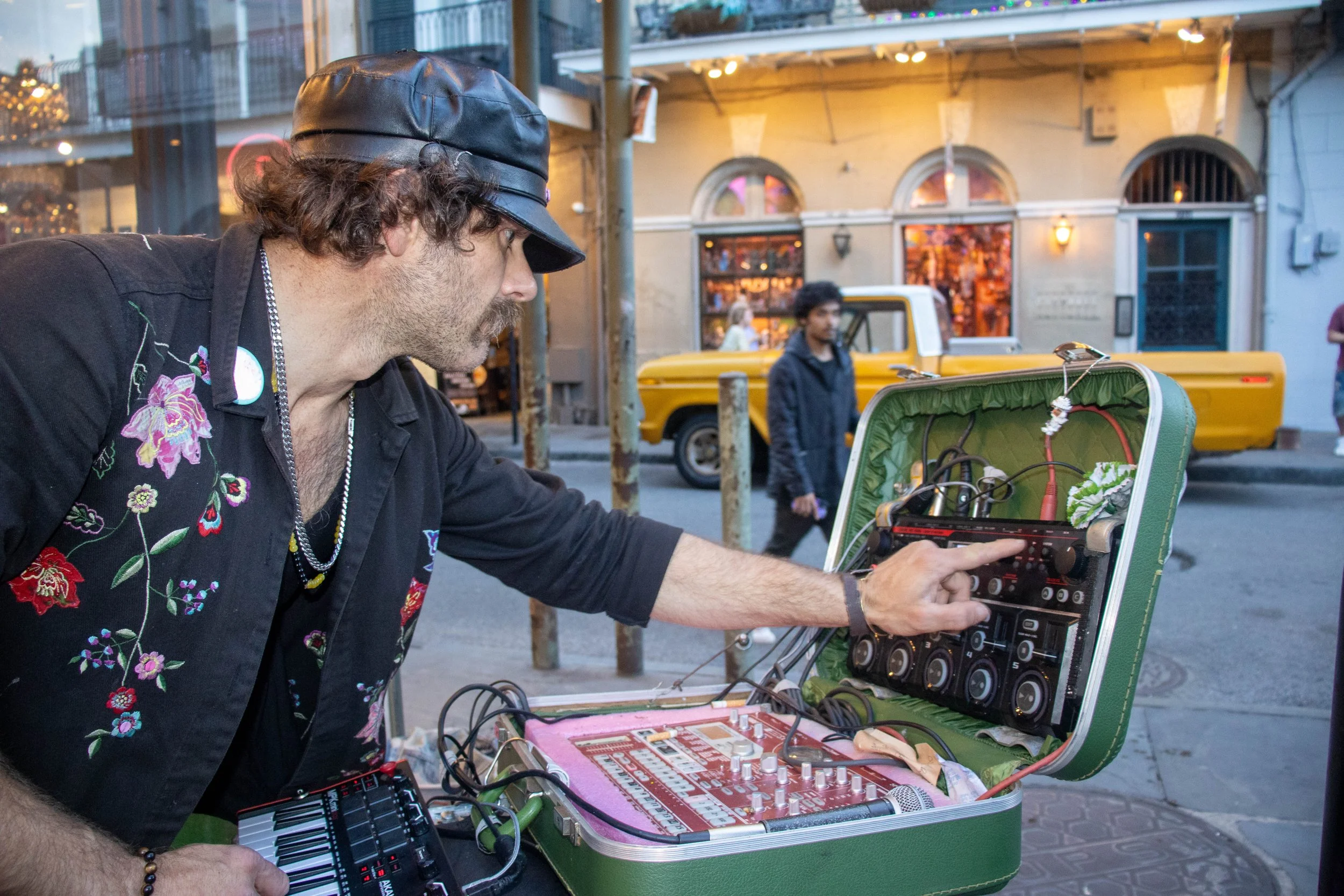 Gabriel Paul sets up his intrument, a vintage hard-shell case retrofitted with a mixer, effects, and MIDI keyboard, which he brings to all performances. He performs on the corner of Royal Street in the French Quarter in New Orleans on Friday, April 1