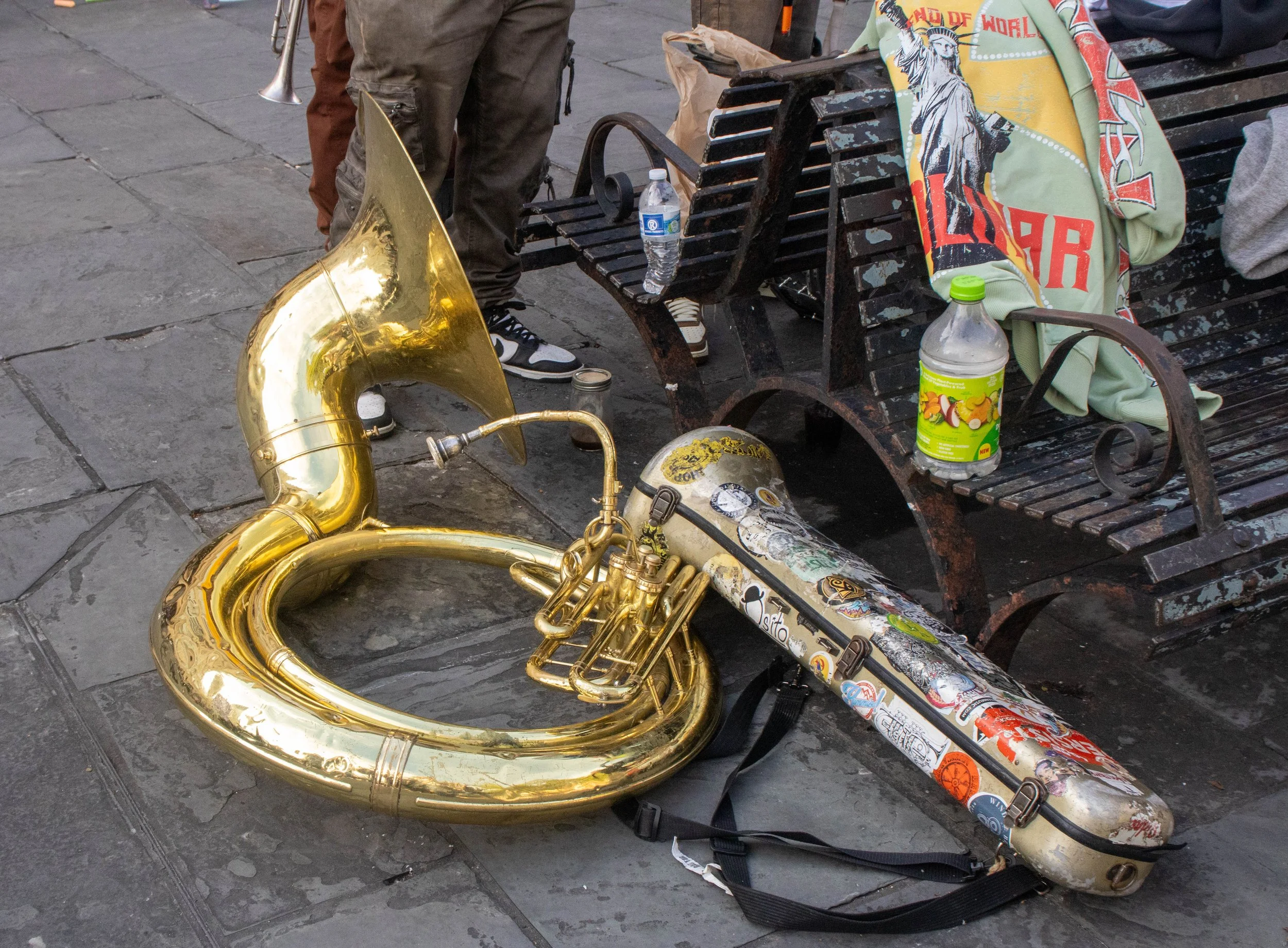 The Voodoo Kingz rest their sousaphone next to the benches in the middle of Jackson Square, as they break from their performance during French Quarter Fest in New Orleans on Sunday, April 19, 2026.
