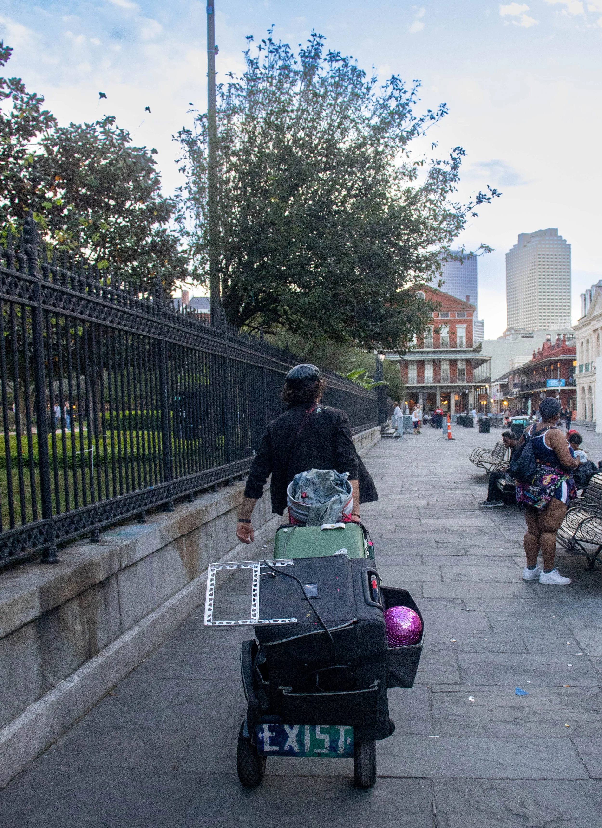 Gabriel Paul scouts Jackson Square for a spot to set-up for his evening performance in in the French Quarter in New Orleans, on Friday, April 10, 2026.