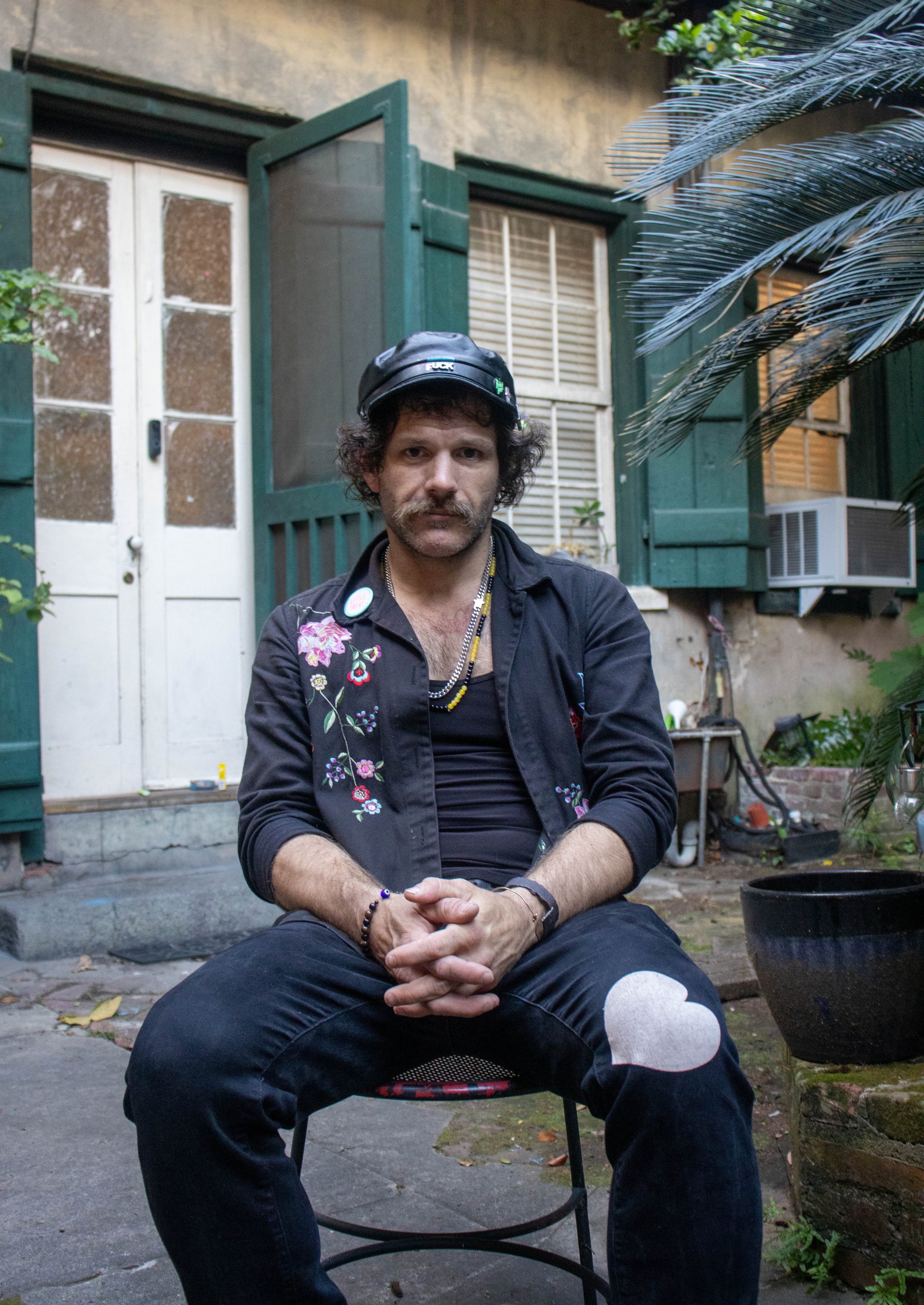 Gabriel Paul sits in the courtyard of his apartment complex on Royal Street in the French Quarter in New Orleans on Friday, April 10, 2026.