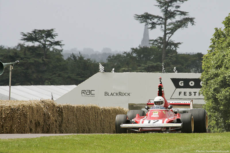 Historic Formula 1 car climbing the Goodwood hillclimb during the Festival of Speed