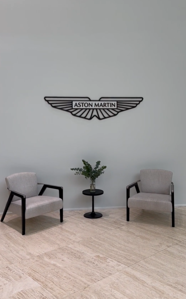 Aston Martin logo displayed inside the factory, symbolizing the brand’s heritage and modern design philosophy