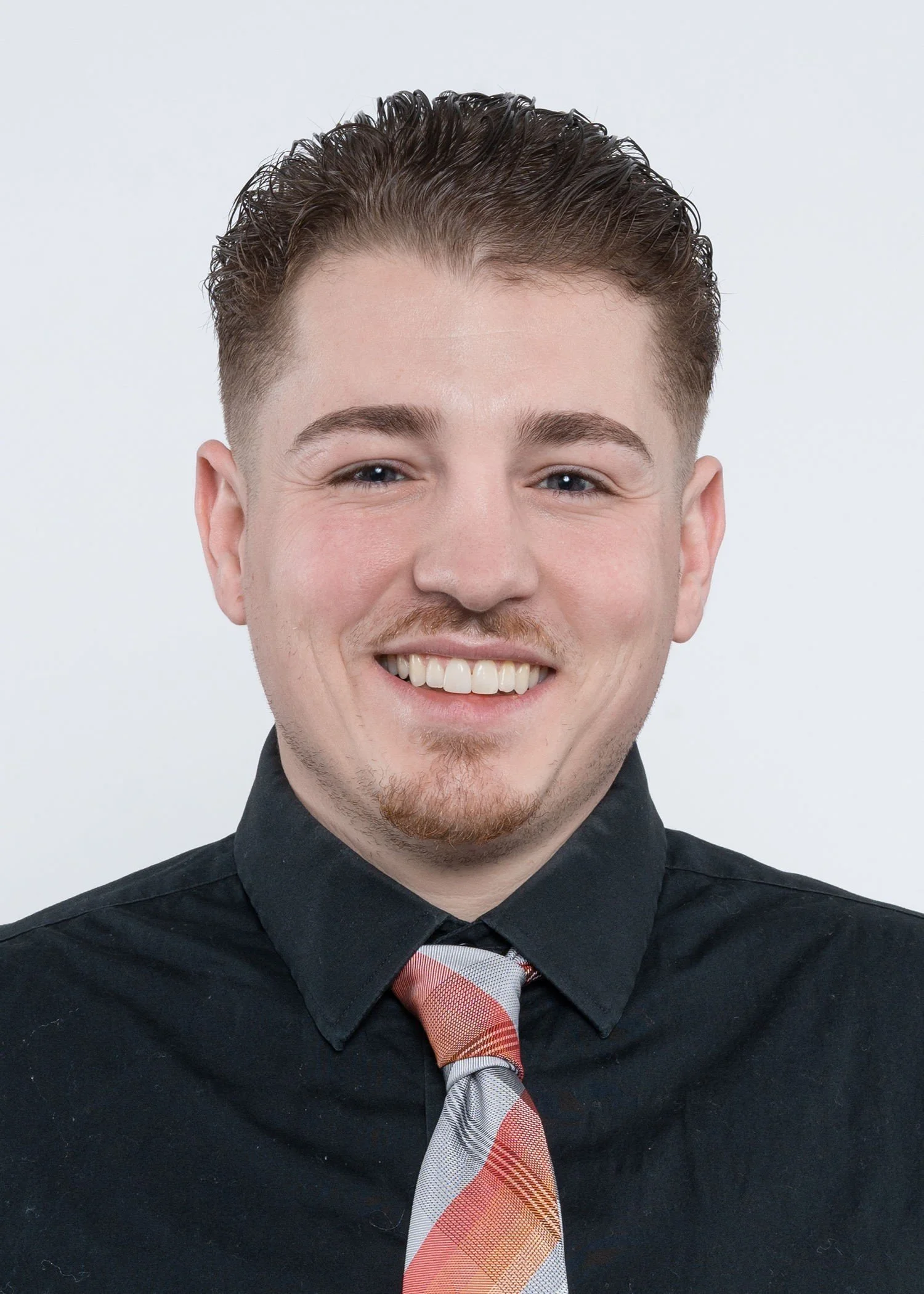 A man with short hair on gray background