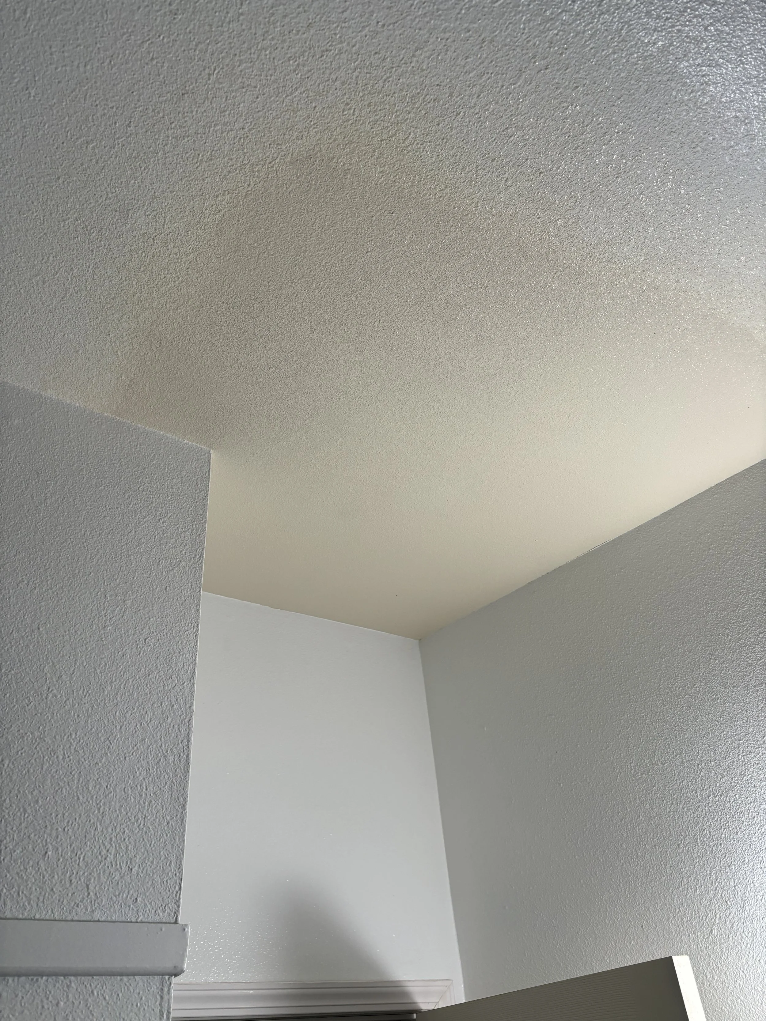 Photo of a freshly textured ceiling patch with part of a wall angle and a door trim visible in the city of Corona, CA.