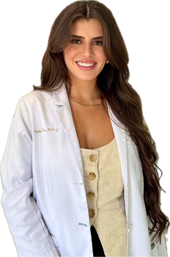 A certified physician associate with long brown hair smiling, wearing a white lab coat over a beige top with large buttons.