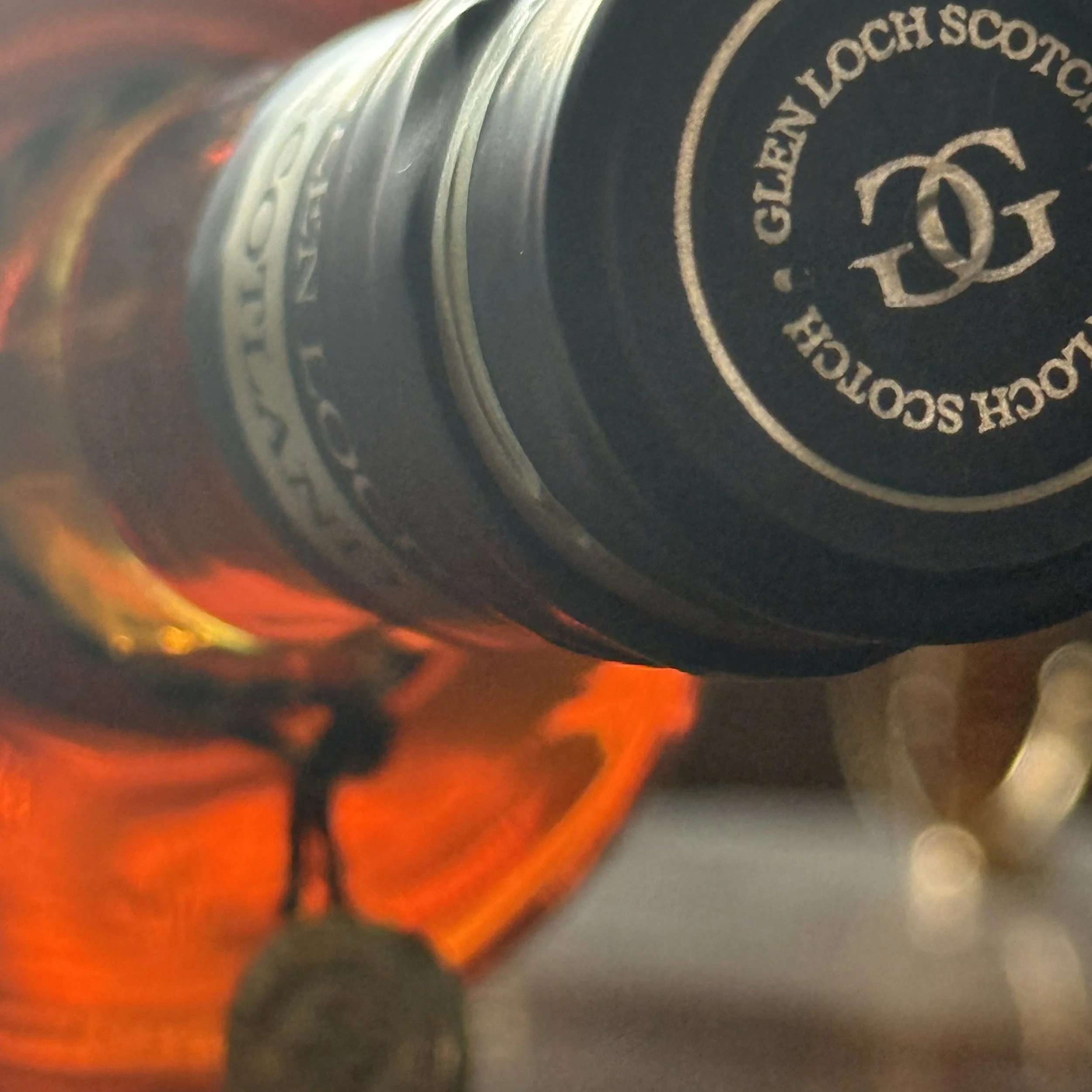 Glen Loch Single Malt Scotch closeup bottle with the emblem on the top of the closure.