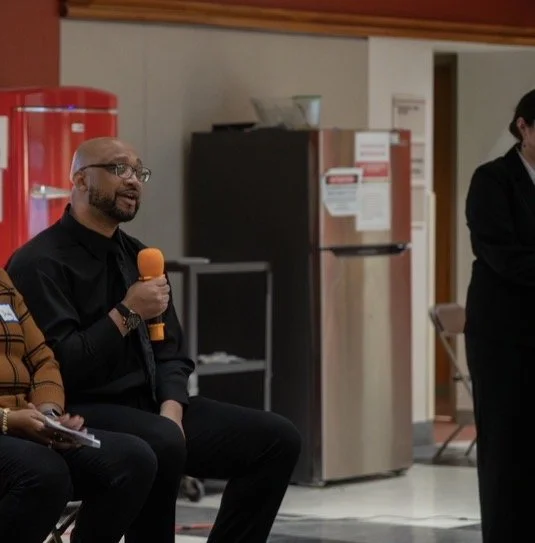 hawn Robert Johnson speaking at a community event, sharing his journey of transformation, second chances, personal growth, prison reform awareness, mentorship, and inspiration through Saving Souls Synergy.
