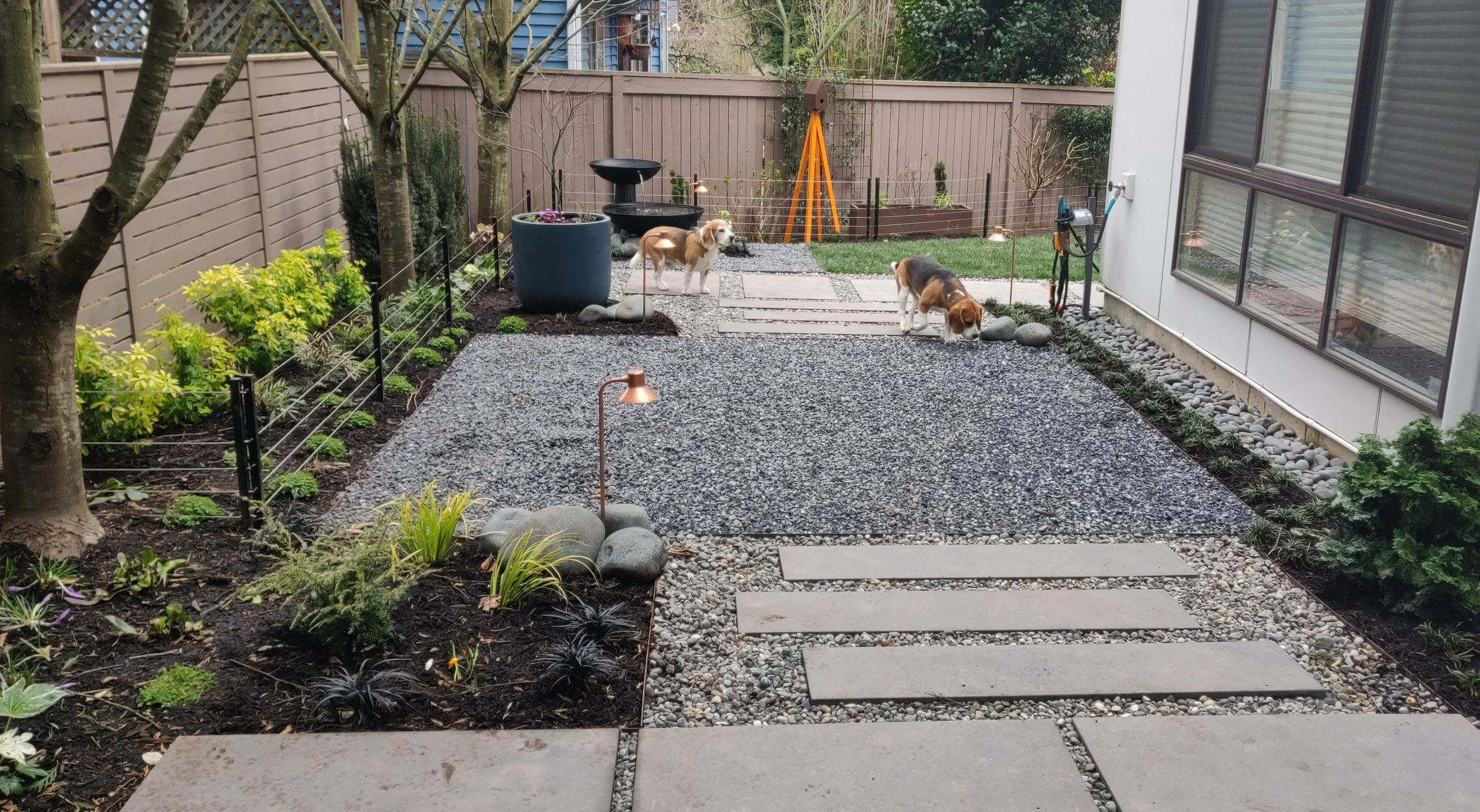 An ‘after’ image showing the finished gravel seating area and plantings.