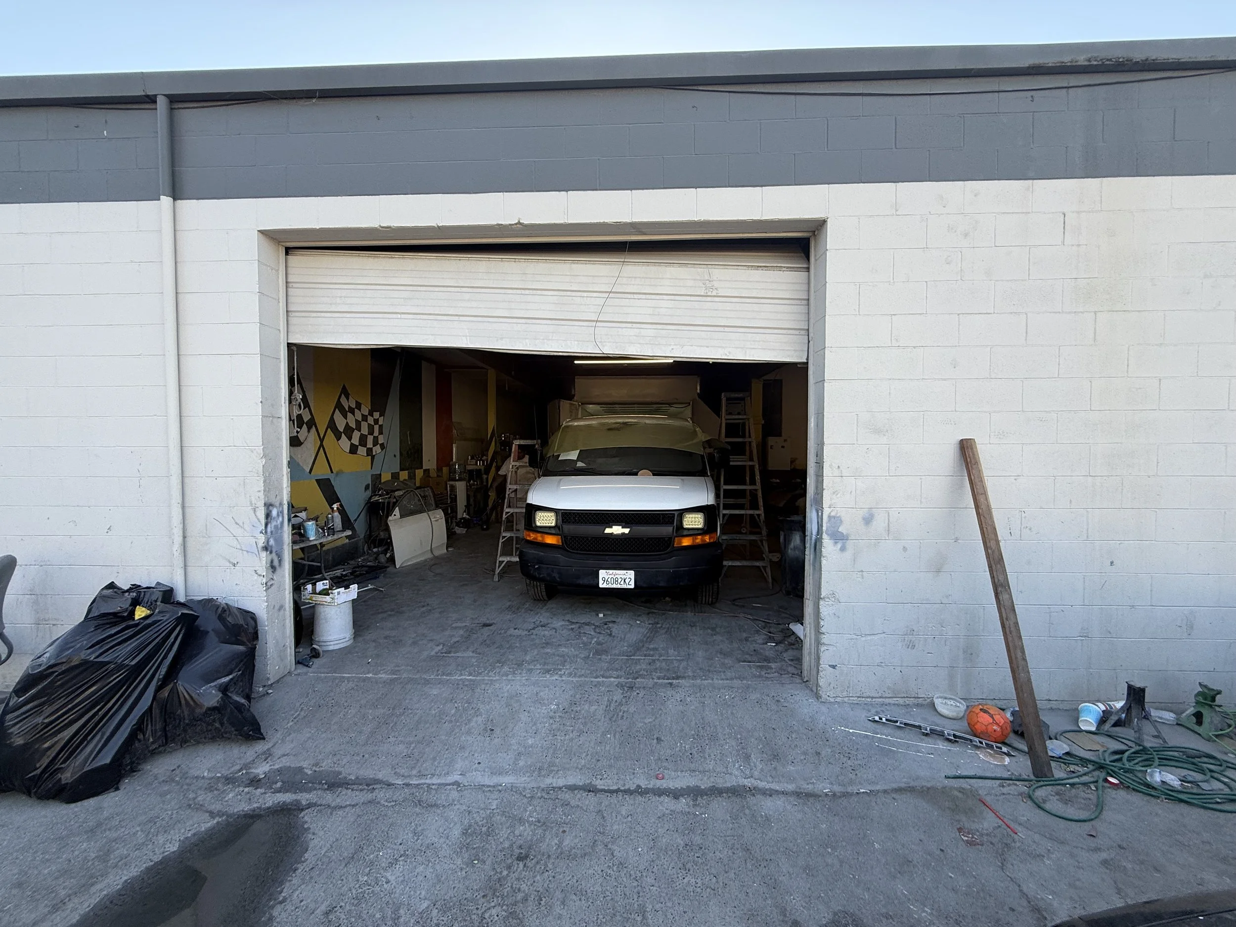 Garage door repair for a door that has come off its track, with a vehicle inside the garage