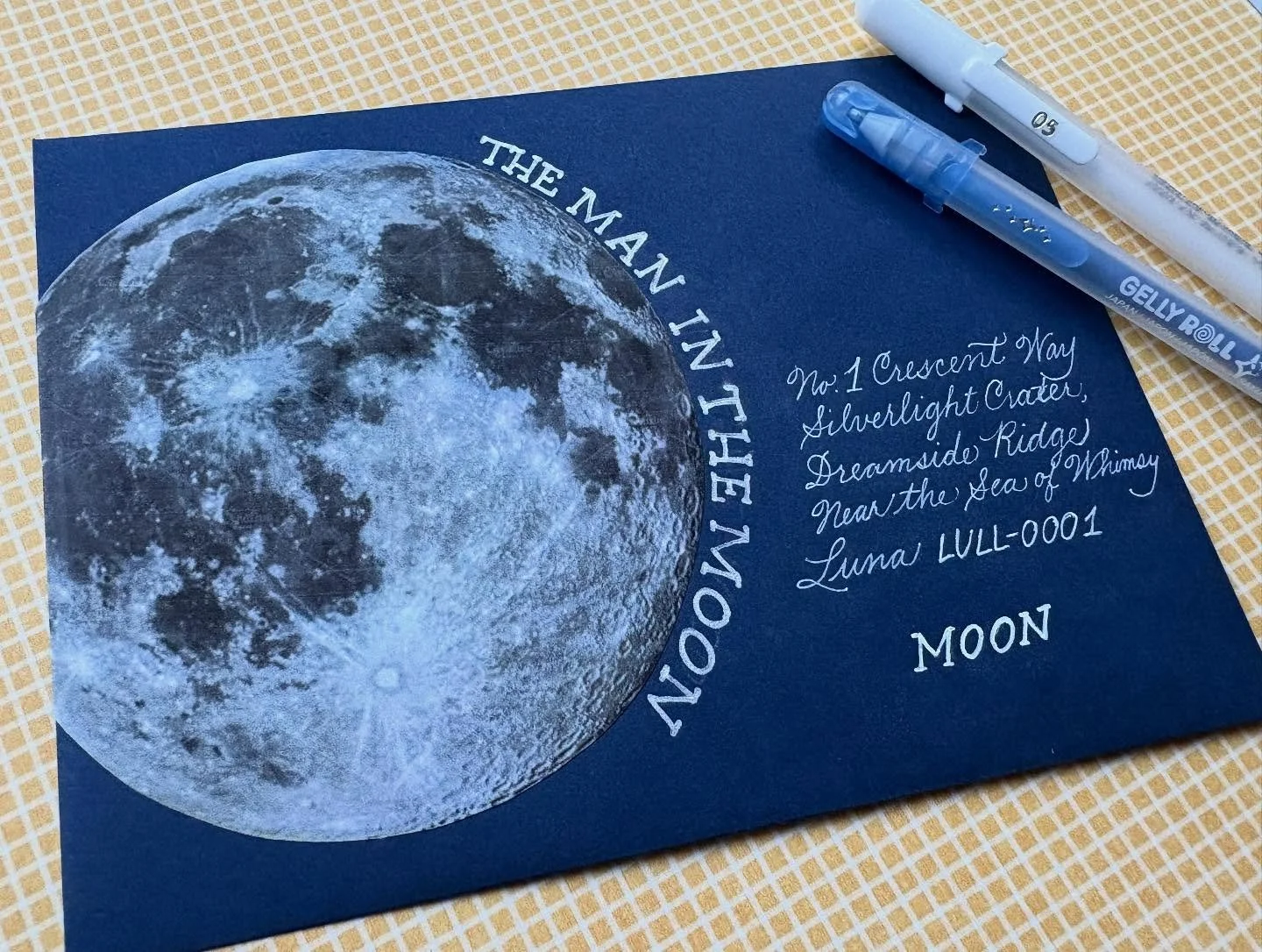 Day 13: Celestial 

🌙  I really liked what ChatGPT came up for the address of the man in the moon. 😏 Loved my Gelly Roll pens on this navy envelope. 

#thisisafakeaddress 
@papersource 
#bewitchingenvelopes2025 
#papersource
#gellyrollpens 
@sakura