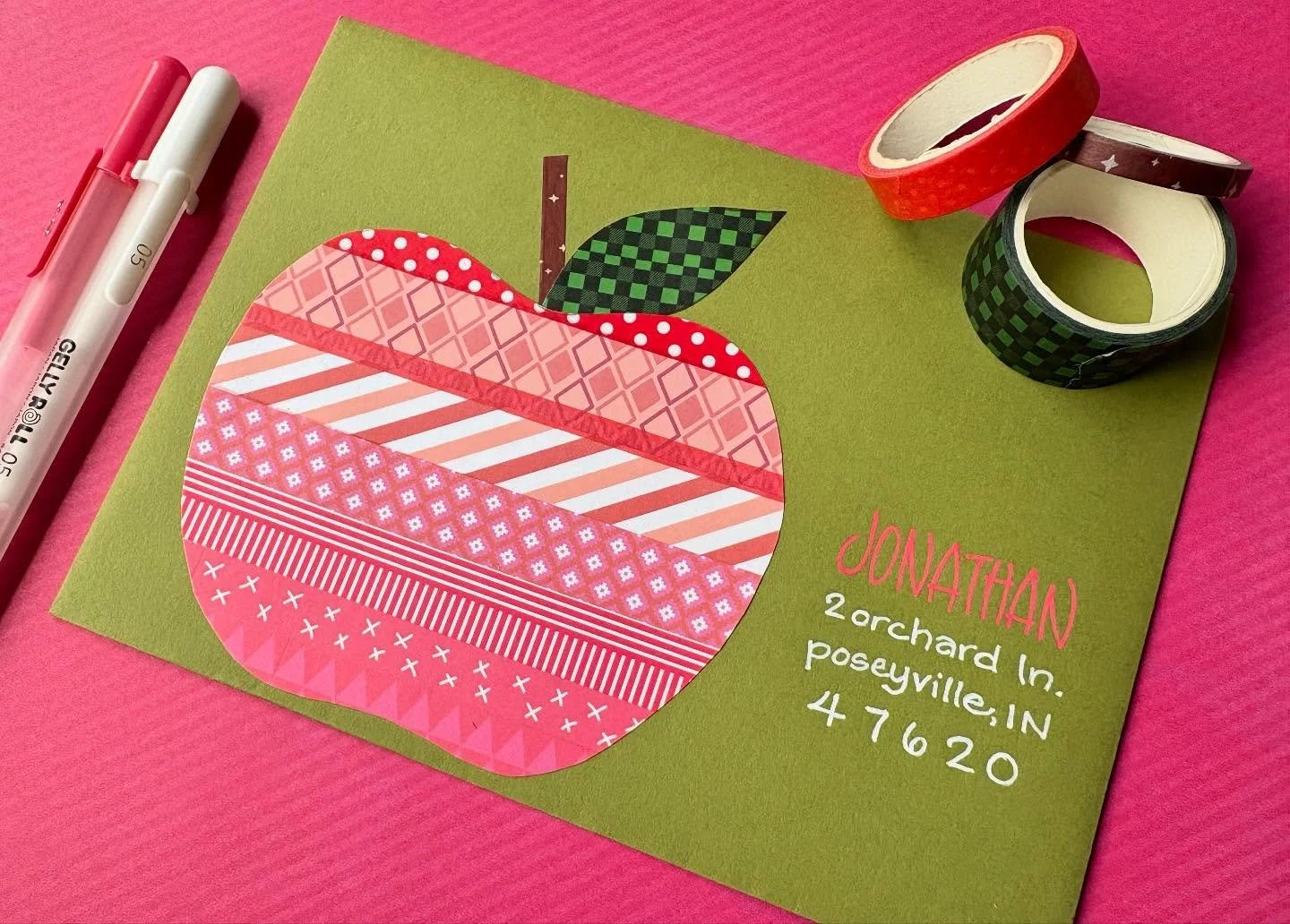 Day 28: Apples ๐ 
I have so much washi tape i decided it would be fun to use it in a new way on these envelopes! I lined up a bunch of red tape on a piece of paper, drew an apple on top and cut it out  and glued it to this envelope. Easy! Also scro