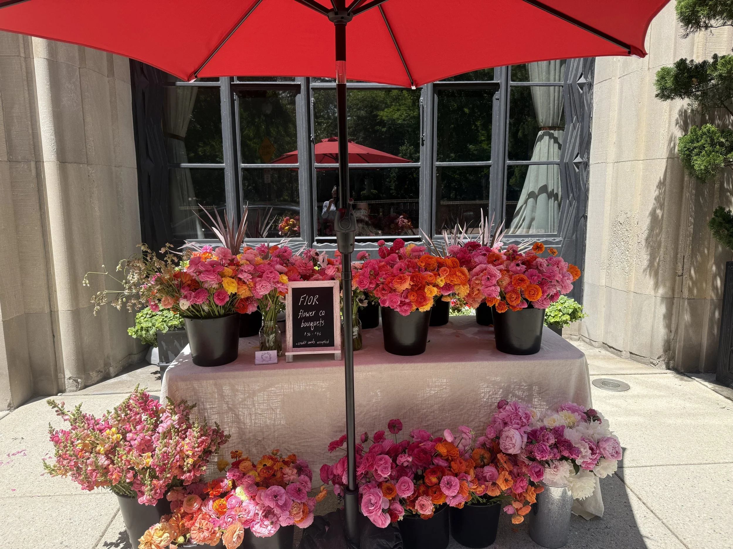 Buckets of colorful ranunculus flower bouquets outside Talula's Table in Kennett Square, PA