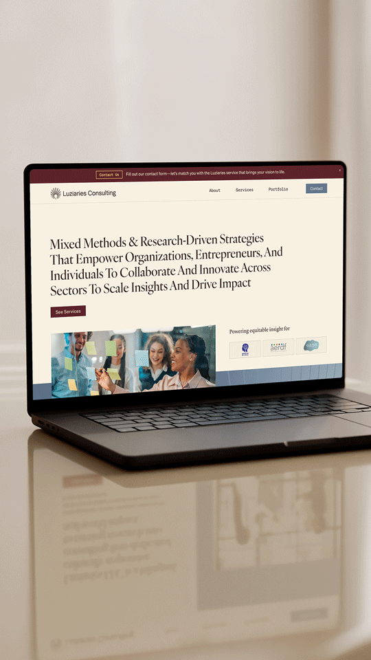 Laptop displaying the homepage of Luzaries Consulting website, with a navigation menu and a main message about strategies for collaboration and innovation.