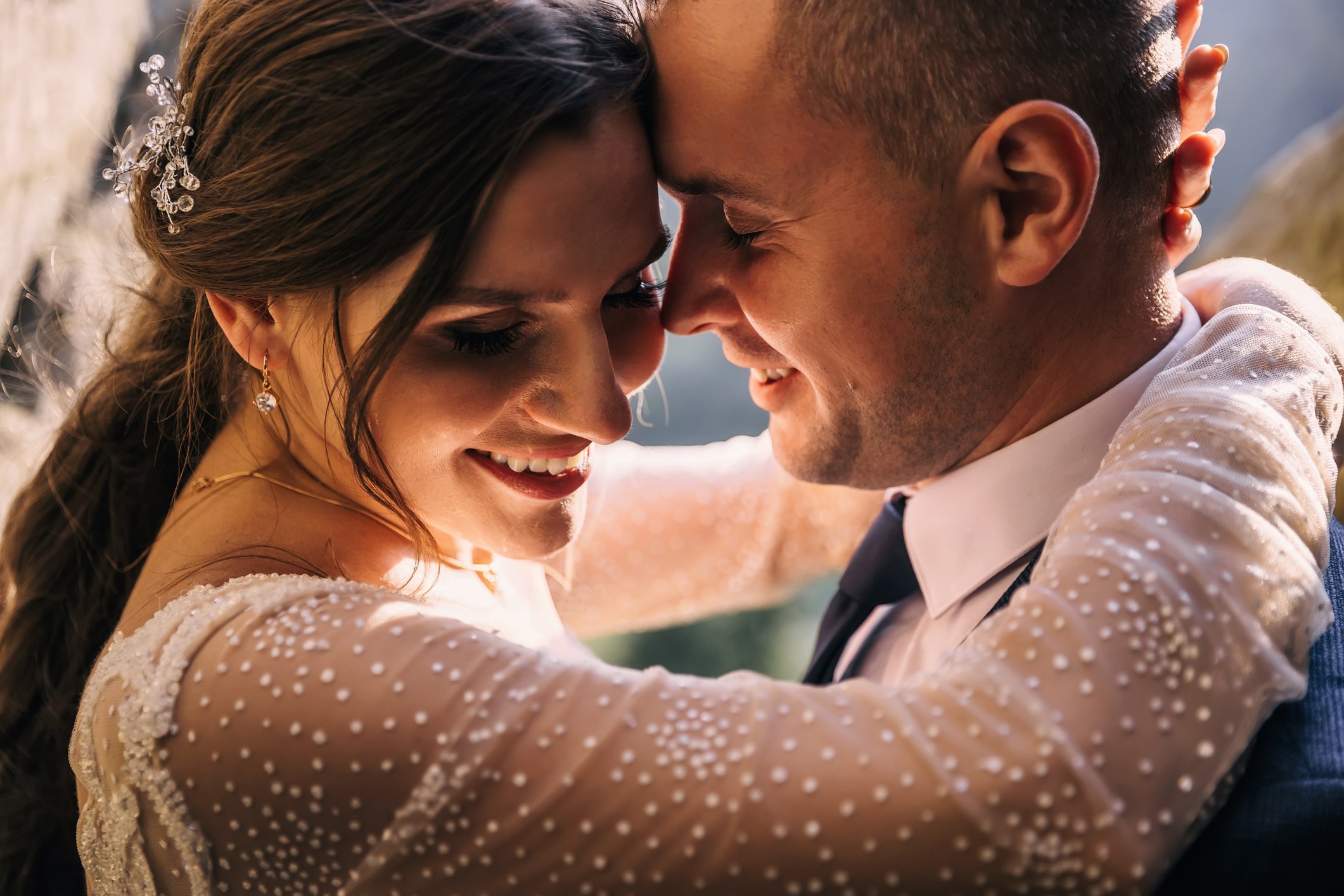 bride and groom with flowers in sunlight