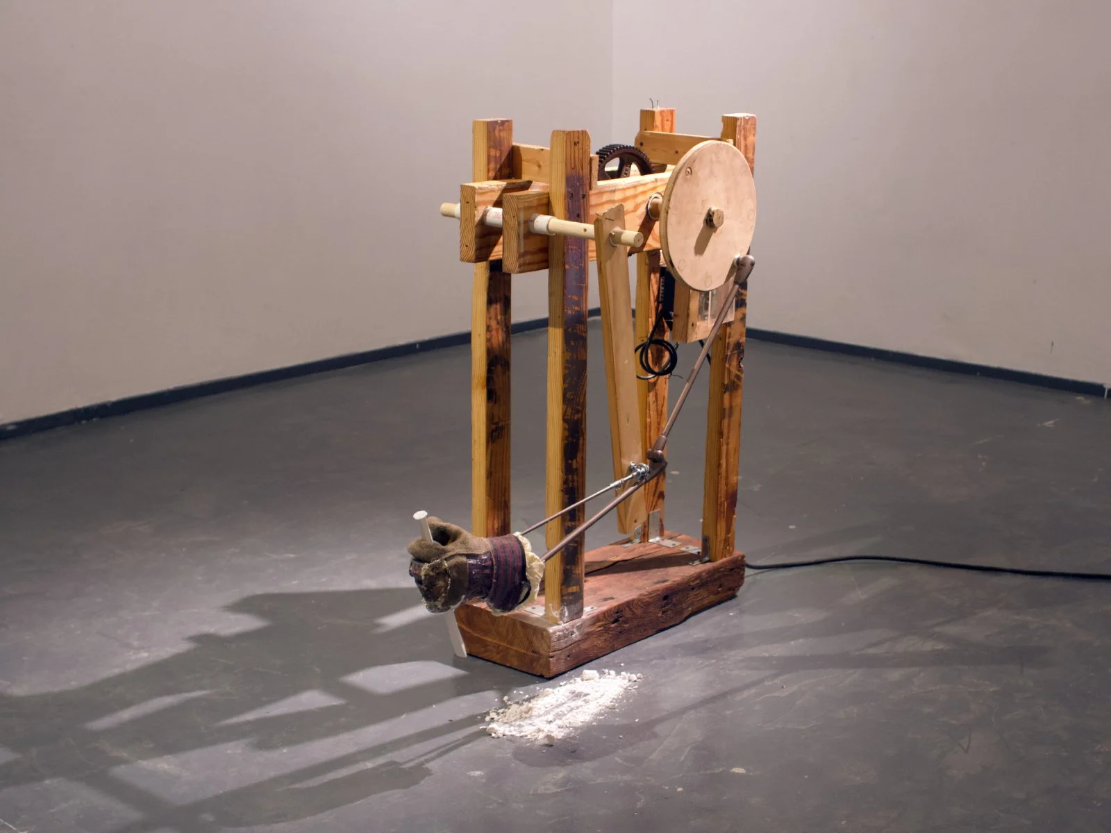 rudimentary kinetic sculpture/machine with arm and chisel