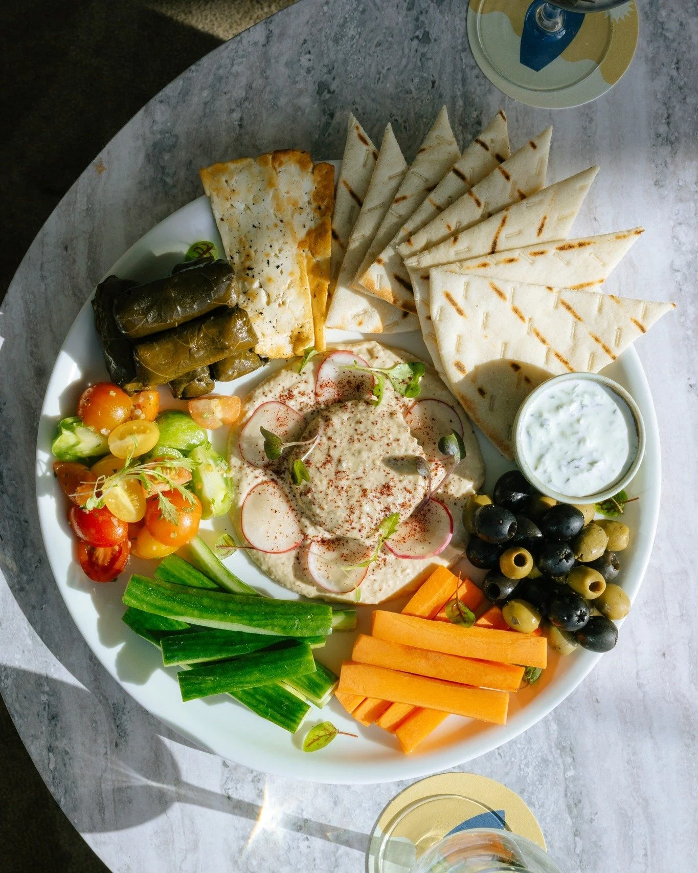 A little bit of everything, all on one plate. Our Mezze Plate is the perfect pairing for a bevvy by the bay. 🌊