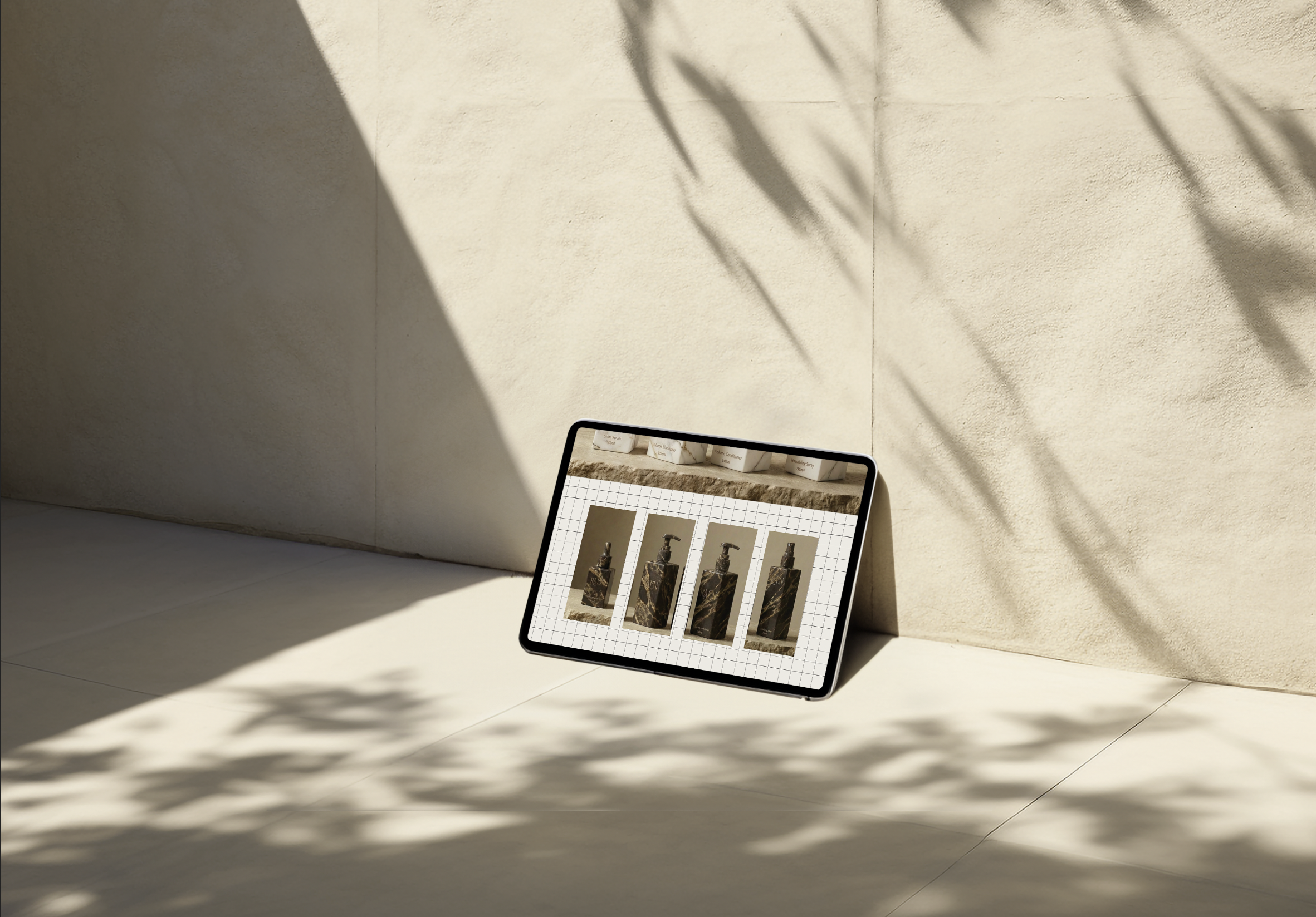 Website design for a hairdressing brand shown on an iPad, featuring product packaging and branding elements.