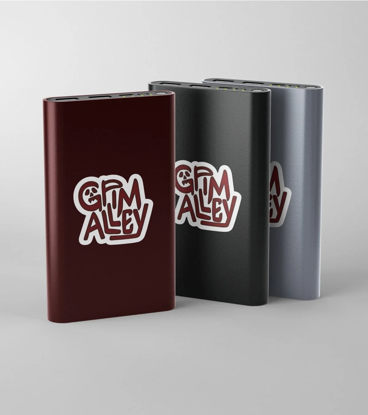 3 phone chargers in red, black and gray with grim alley's logo on the front.