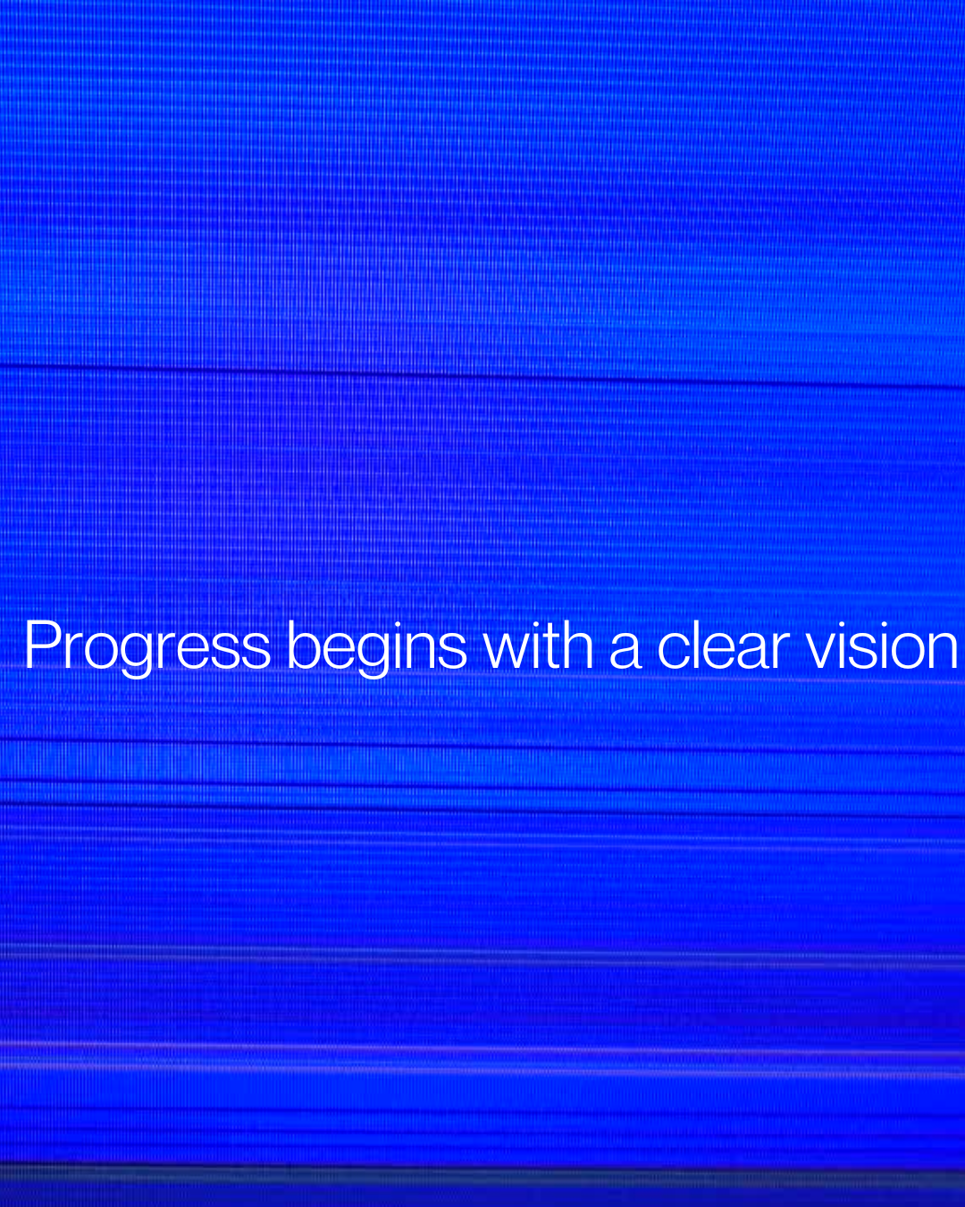 Close-up of a blue digital screen with the phrase 'Progress begins with a clear vision' written in white text.