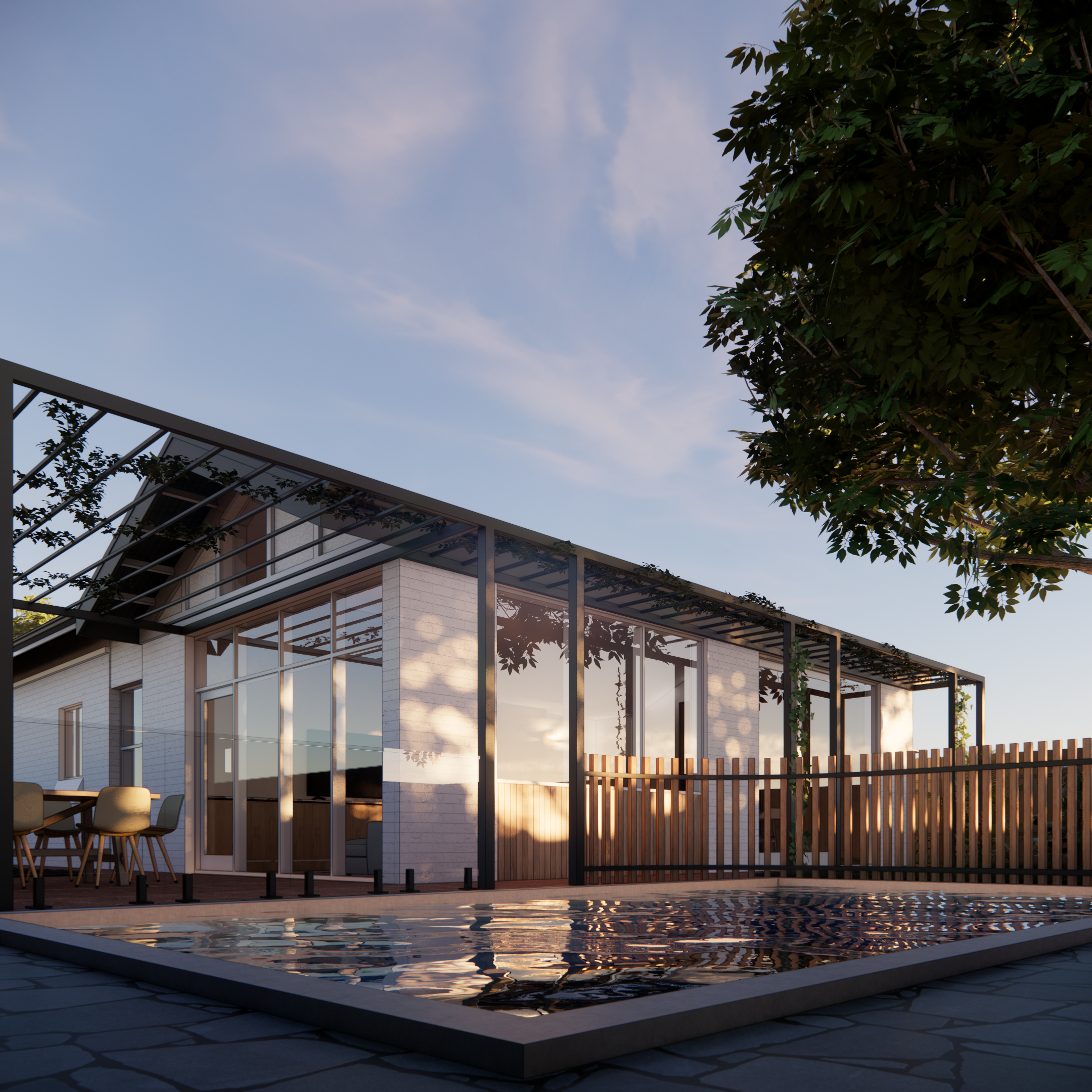 Modern house with large glass windows, outdoor dining area, and a reflecting pool in the foreground, surrounded by a wooden fence and greenery, under a clear sky.