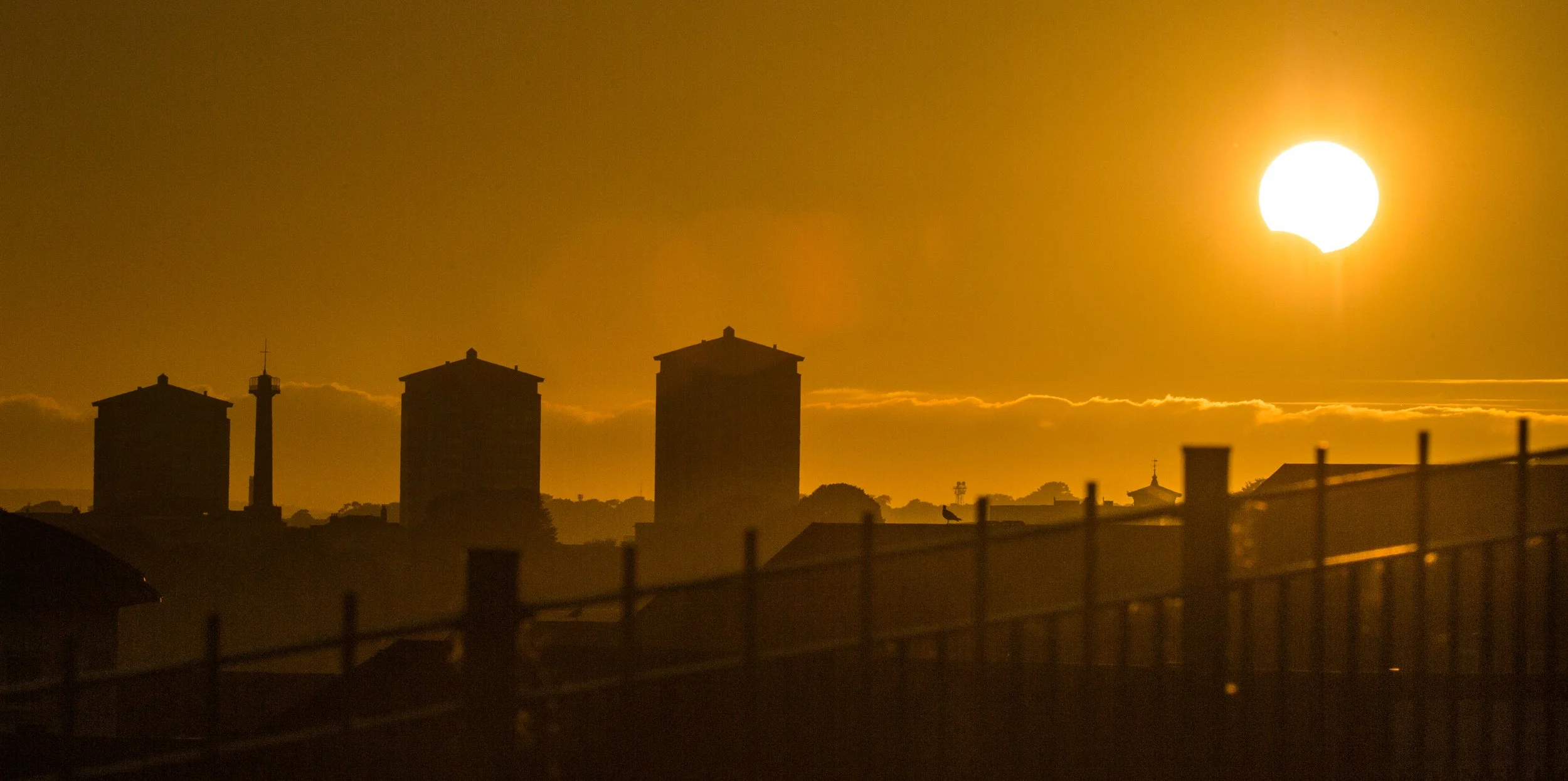 A partial solar eclipse as seen in Plymouth looking towards Devonport and Mountwise, Devon, England.