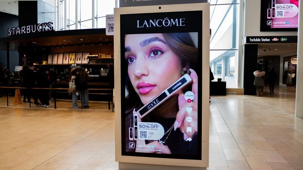 Lancome digital advertisement in mall near Starbucks