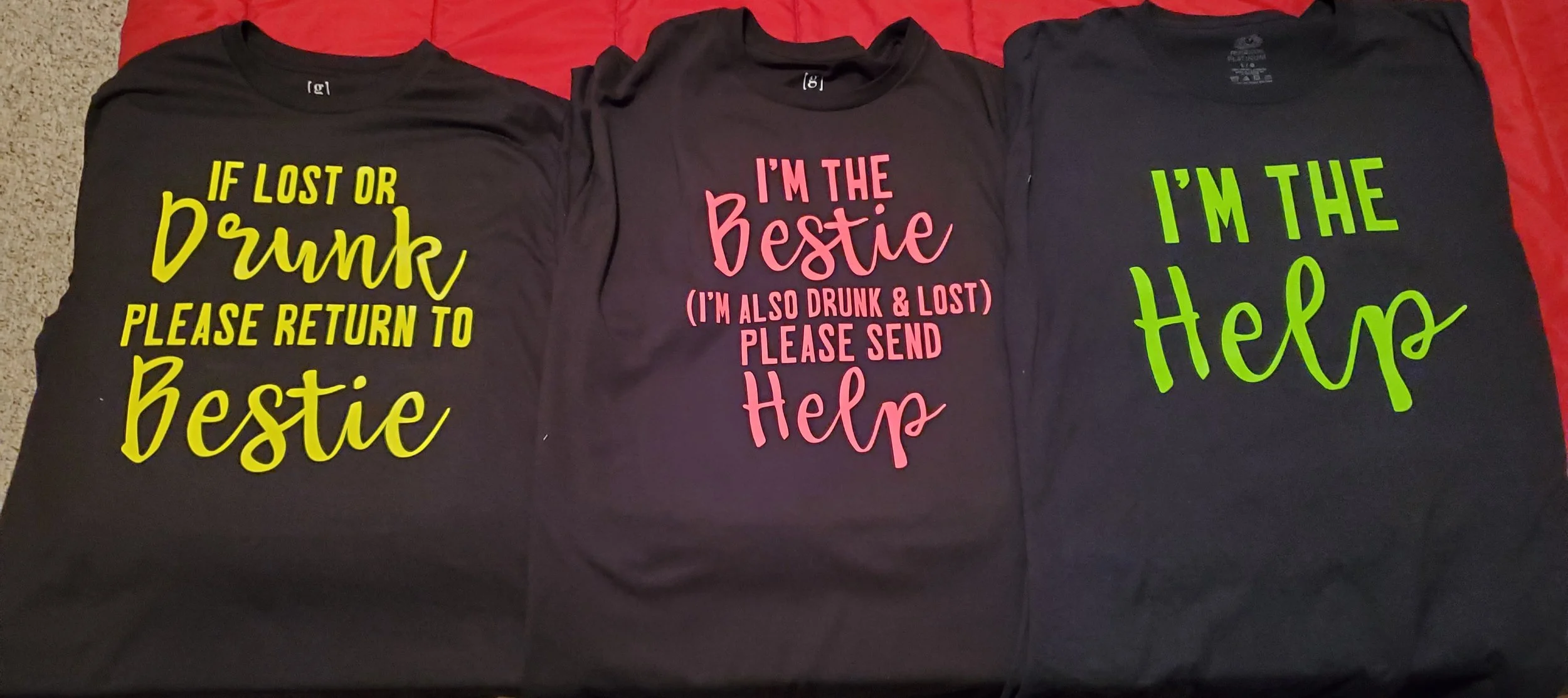 Three black T-shirts with colorful text and humorous messages for dogs. The first shirt has yellow text that reads, "If lost or drunk please return to bestie." The second shirt has pink text that says, "I'm the bestie (I'm also drunk & lost) please s
