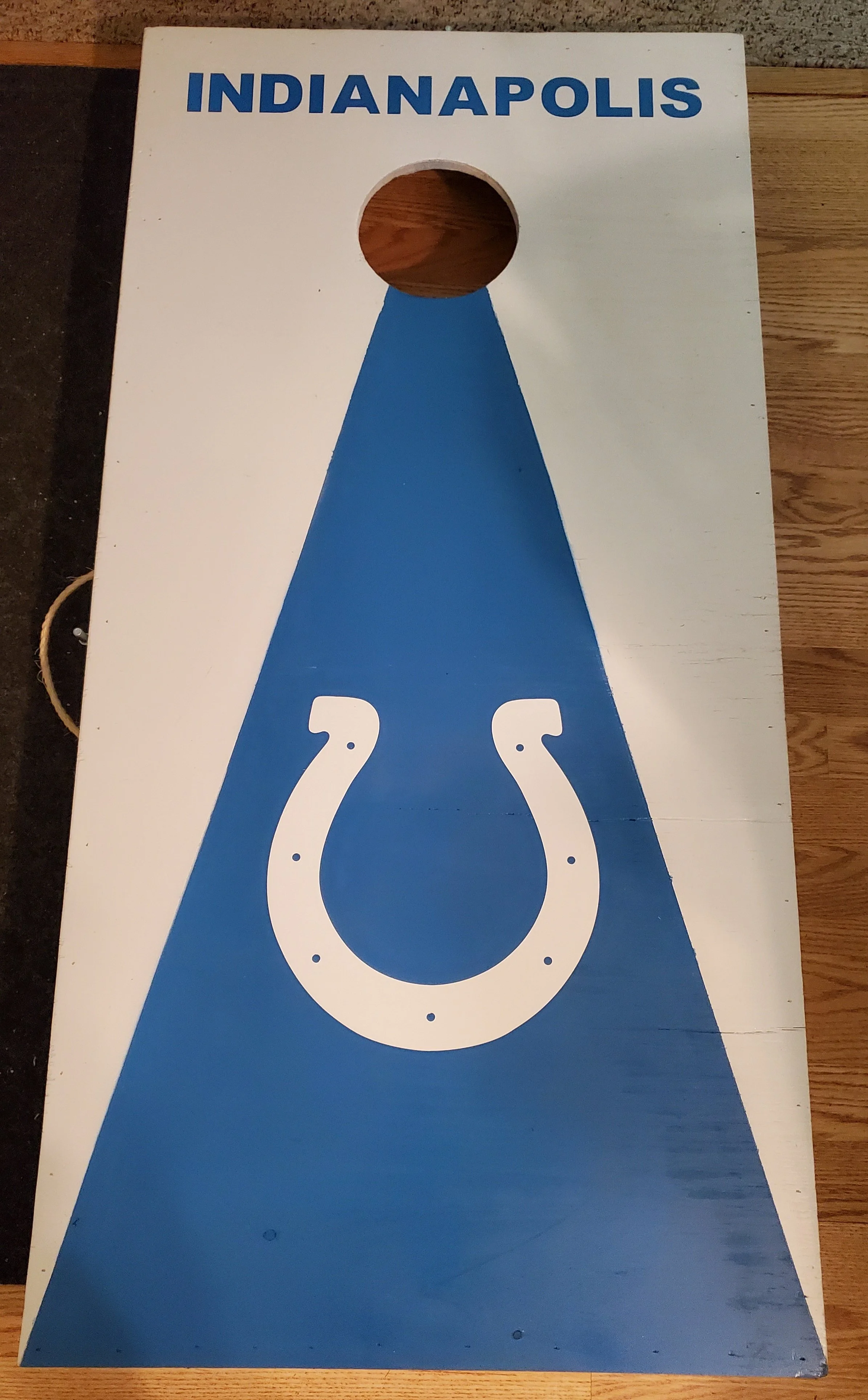 Cornhole game board with a white background, blue accents, and a horseshoe design, featuring the word 'INDIANAPOLIS' in blue at the top.