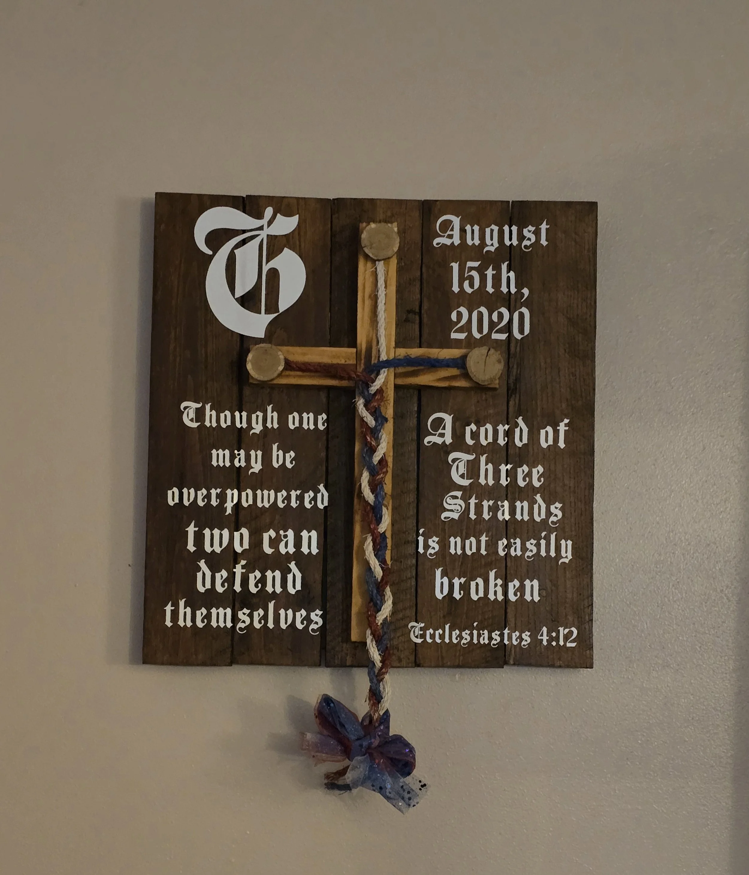 Wooden wall hanging with a cross and Christian quote, displaying the date August 15th, 2020.