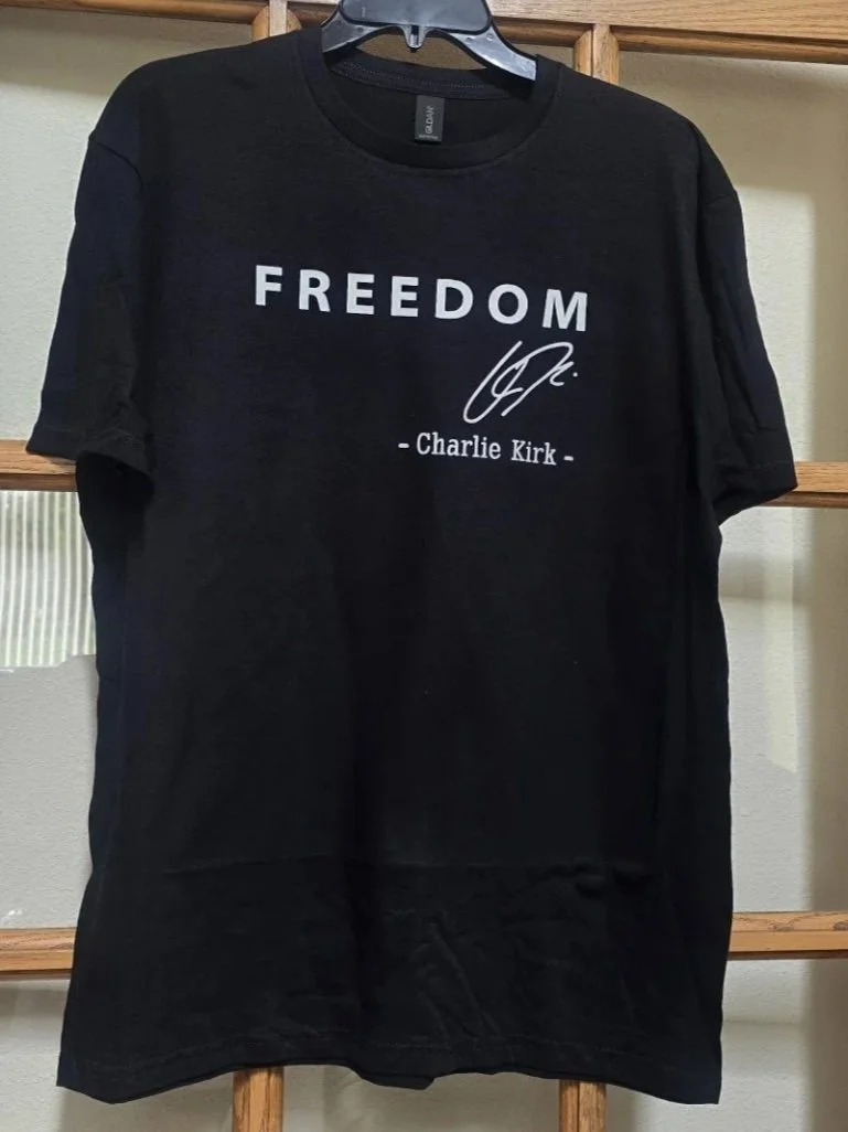 Black T-shirt with the word 'FREEDOM', a signature, and the name Charlie Kirk printed on it.