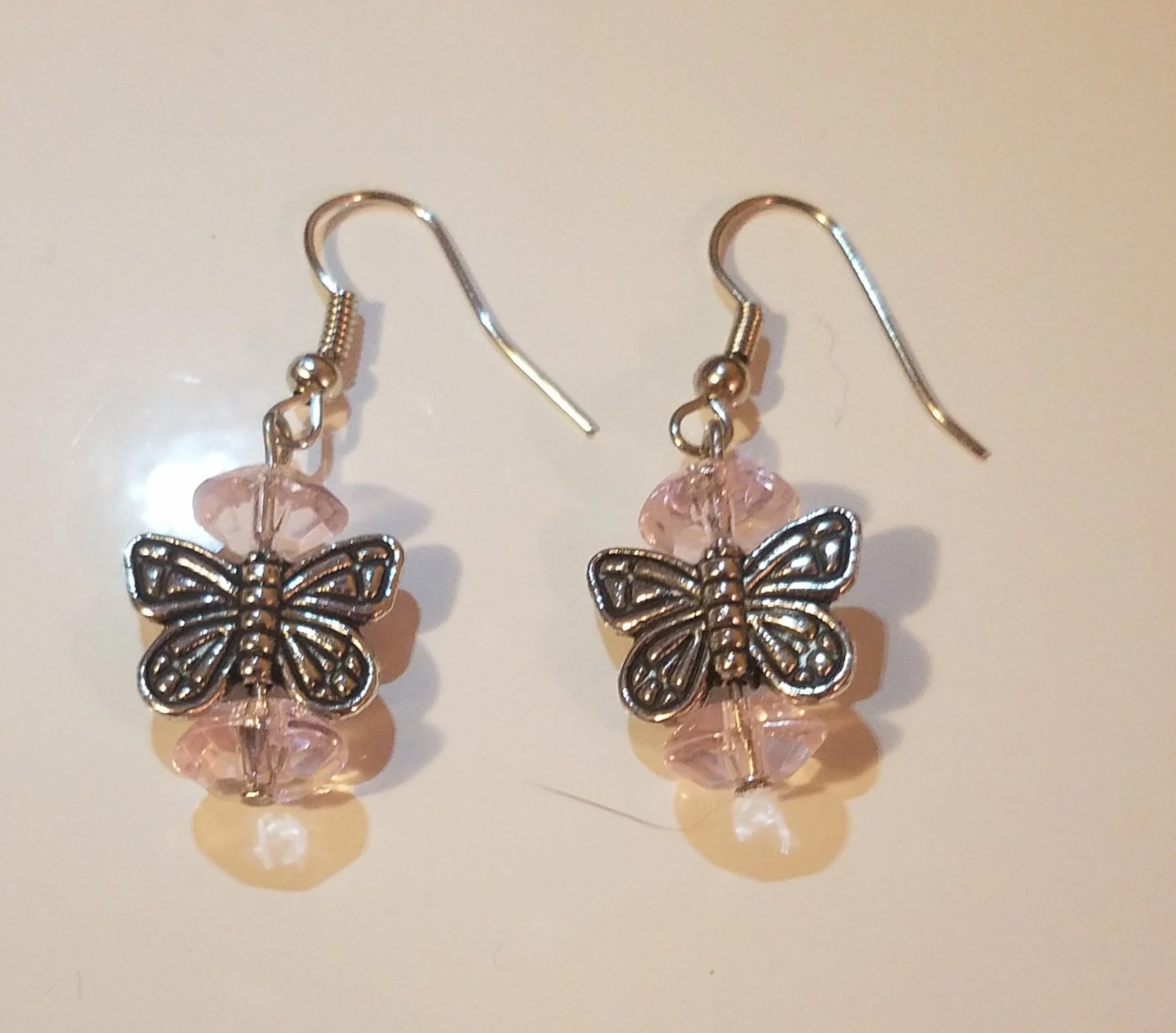 Silver earrings with butterfly charms and pink beads