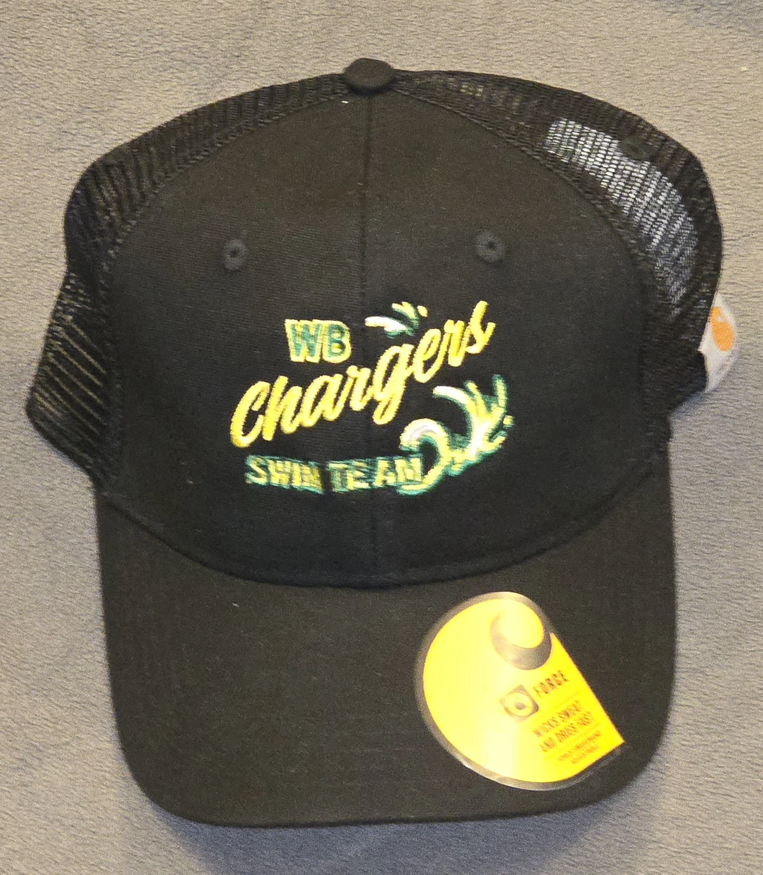 Black trucker hat with embroidered text and design that reads "WB Charley's Shark Team" in yellow and green threads, with a shark fin and splash graphic, on a gray surface.