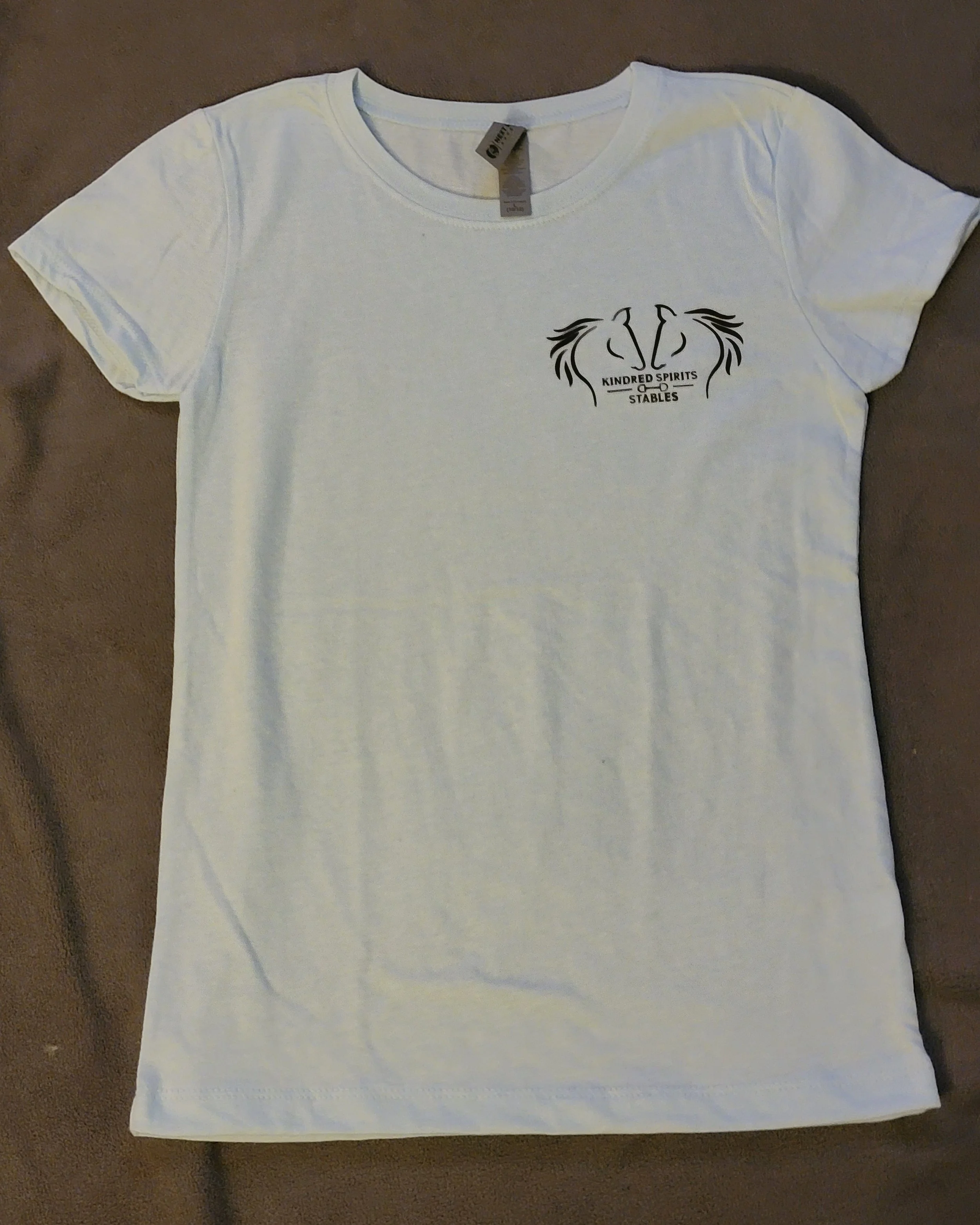 White T-shirt with a black logo reading 'Kindred Spirits Stables' and two stylized horse heads facing each other.