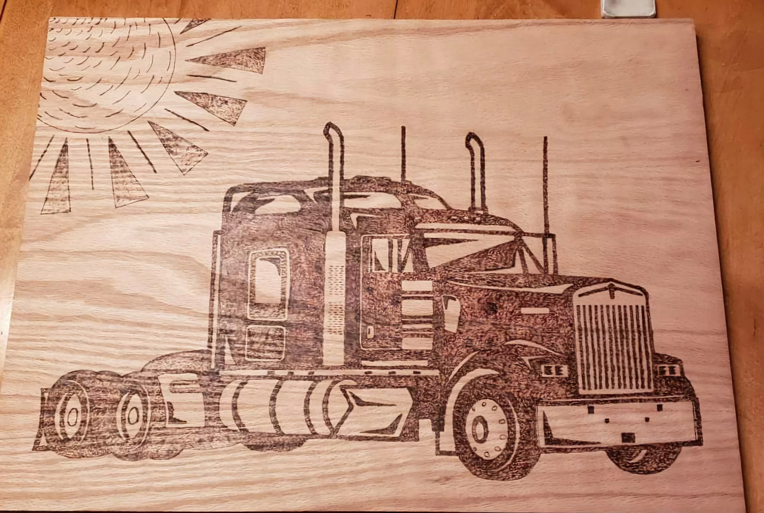 Wooden engraving of a semi-truck with a sun in the top left corner.