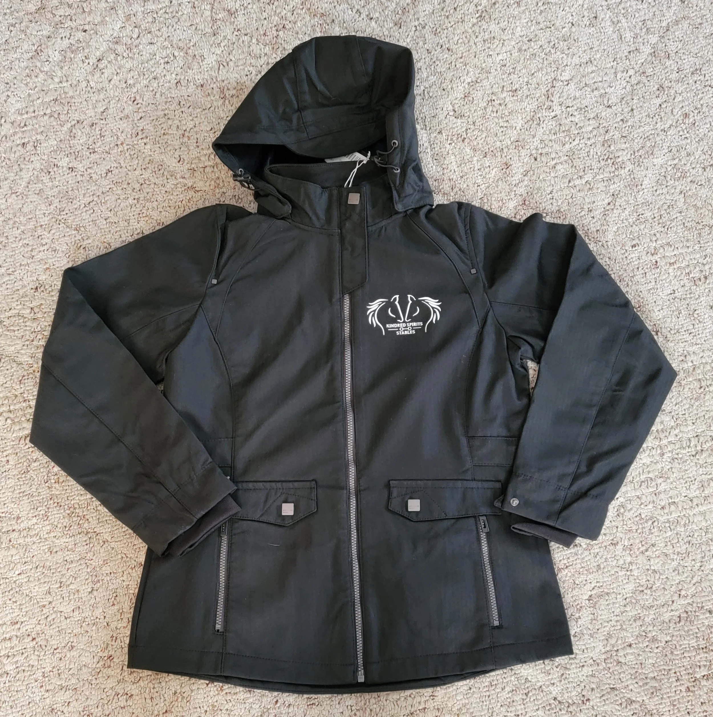 Black leather jacket with a logo on the left chest reading 'Kindred Spirits Stables' and a horse graphic.