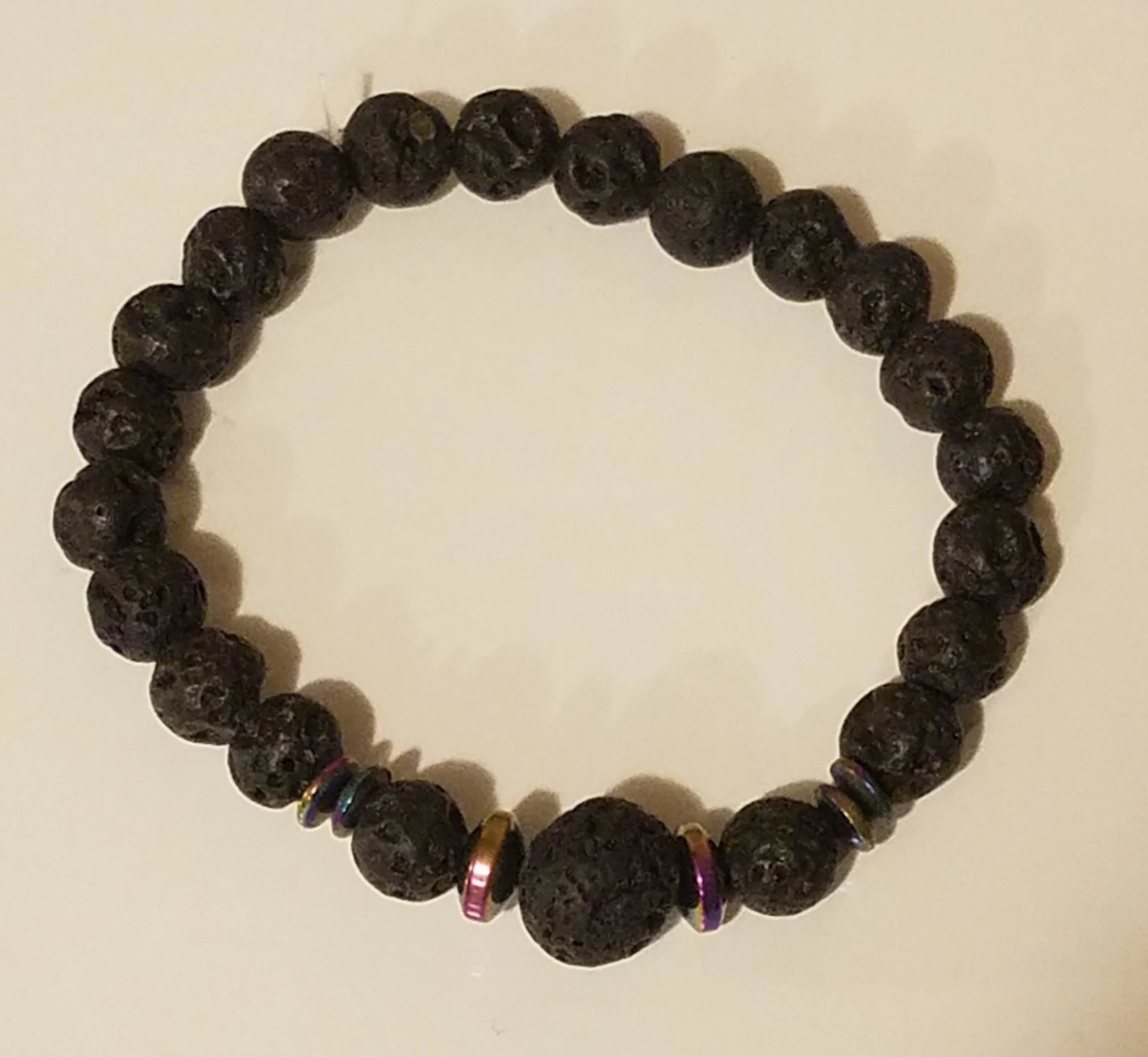 Black volcanic bead bracelet with small metallic spacer beads