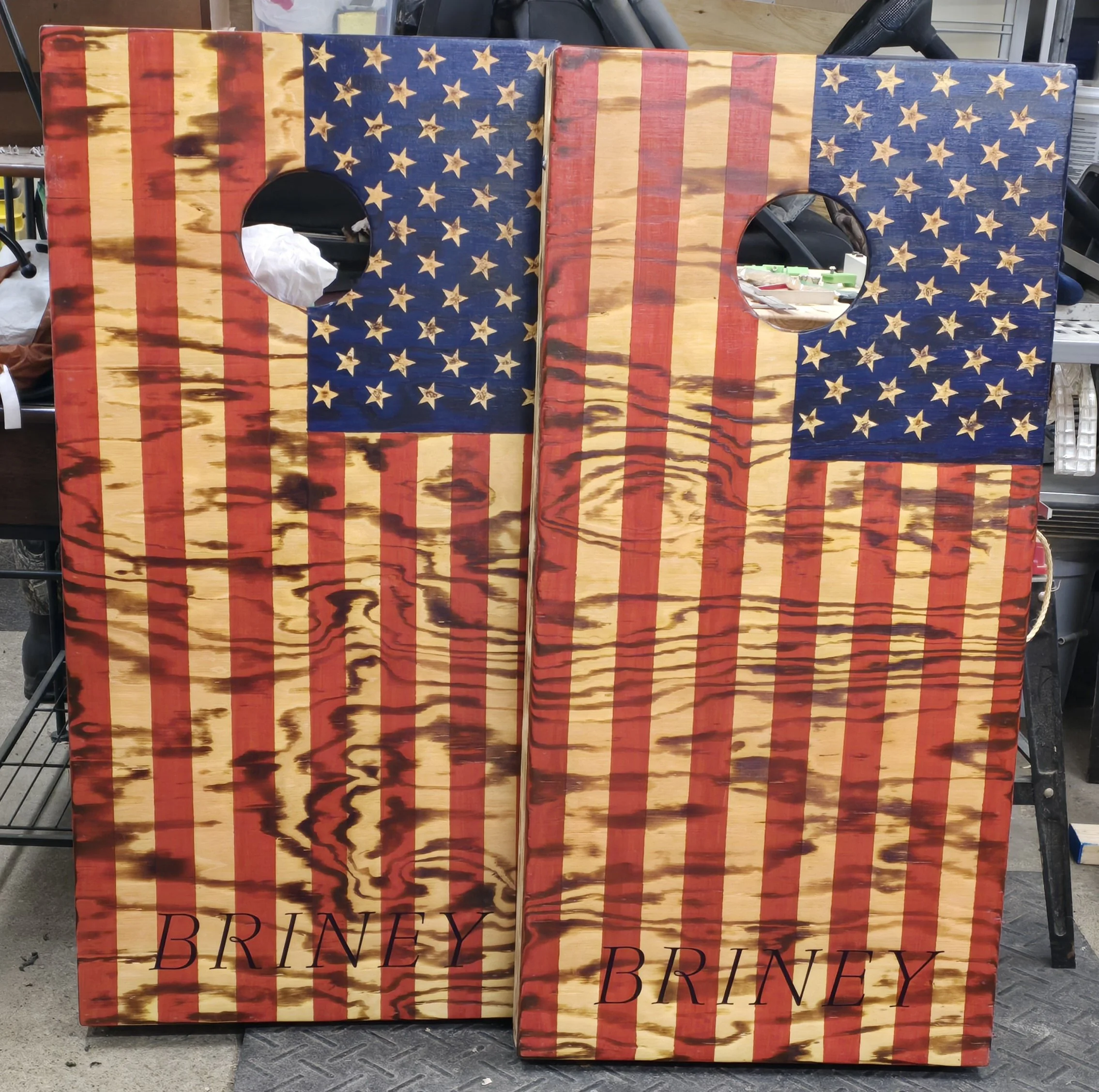 Two cornhole boards painted with the American flag and the name 'Briney' at the bottom.