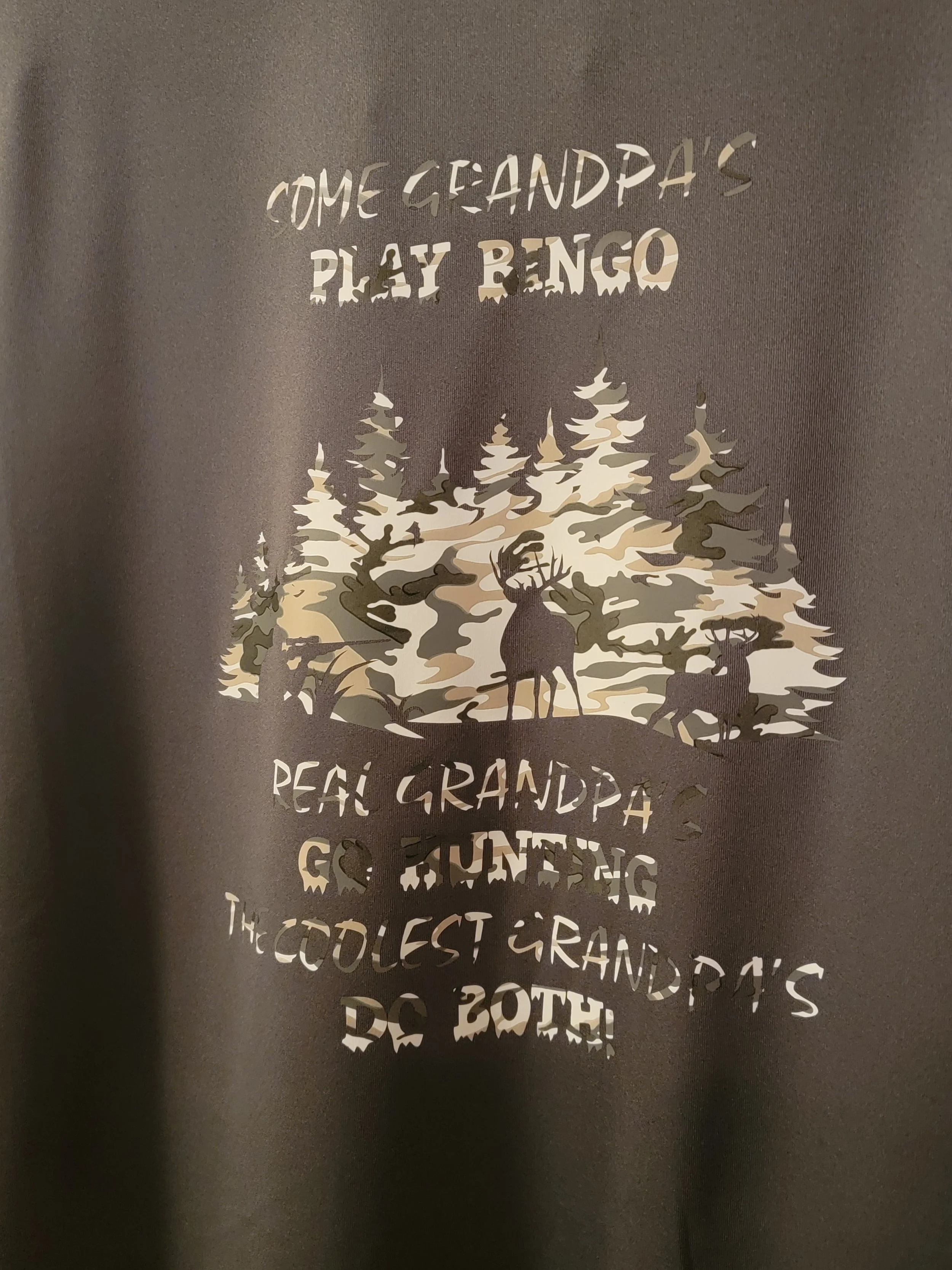 A cutout of trees with two deer beneath, and text reading 'Come Grandpa's Play Bingo, Peace Grandpa & Hunting, The Coolest Grandpa's Do Both!'