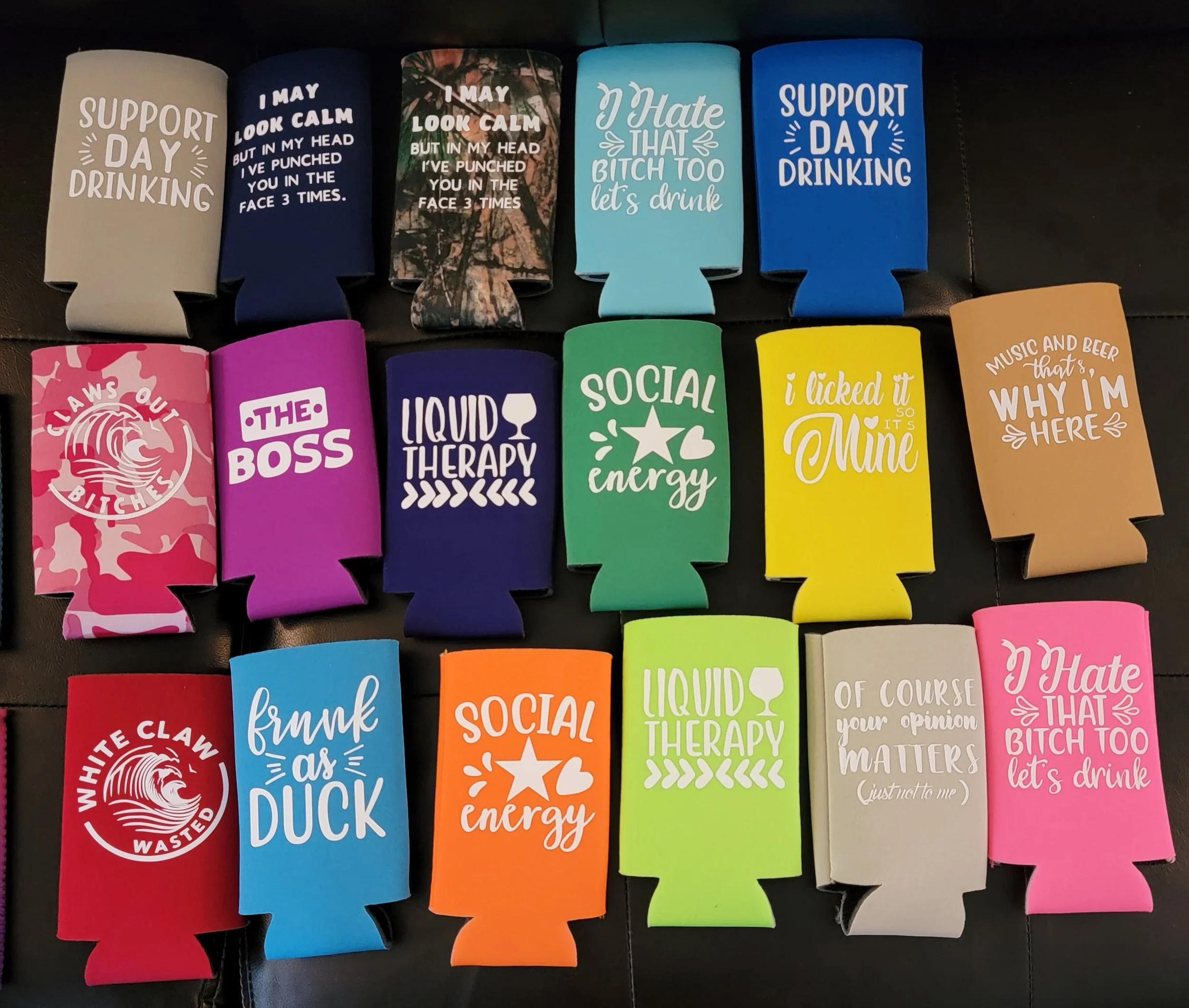 Collection of colorful drink koozies with humorous and sassy phrases related to drinking, socializing, and relaxation.
