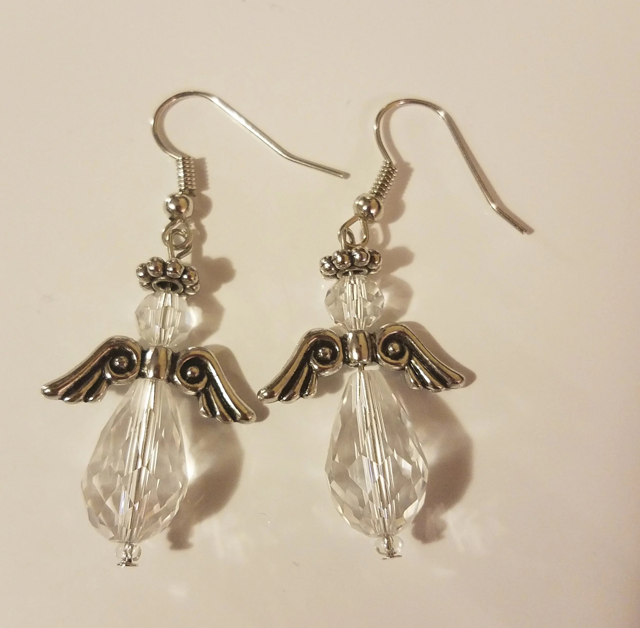 Silver angel earrings with crystal beads and hooks.