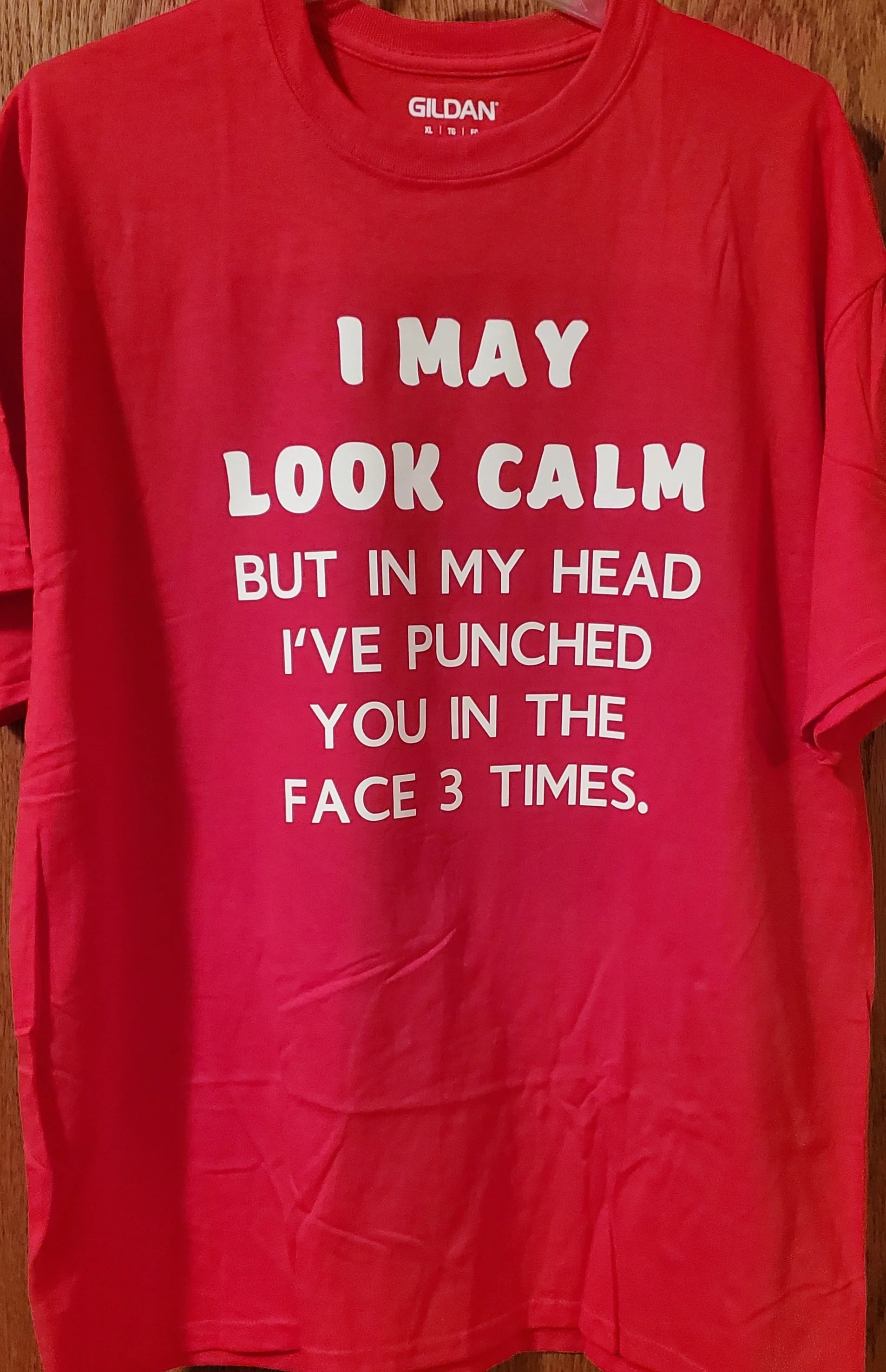 Red T-shirt with white text that reads, "I MAY LOOK CALM BUT IN MY HEAD I'VE PUNCHED YOU IN THE FACE 3 TIMES."