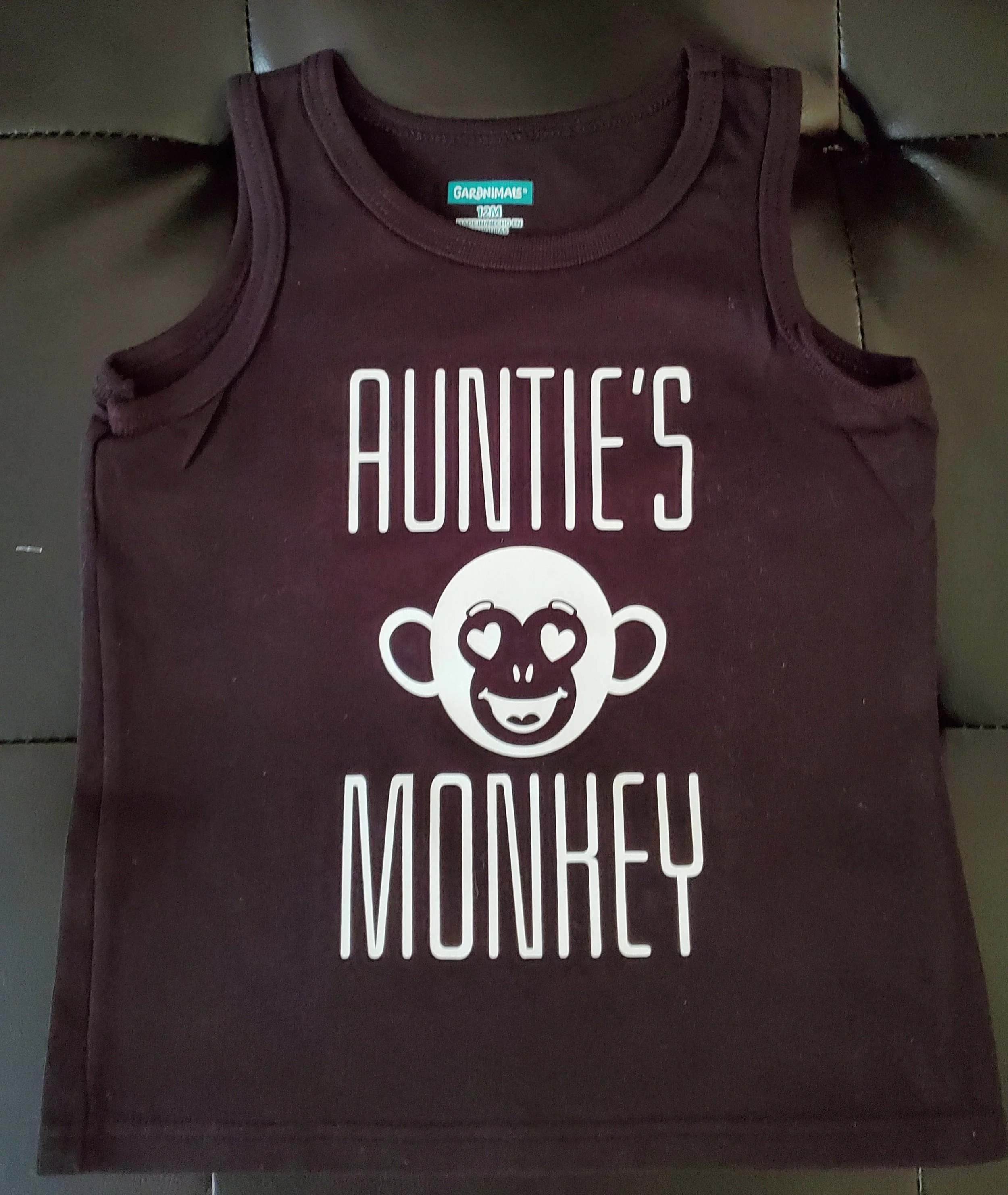 Sleeveless shirt with the text "Auntie's Monkey" and a cartoon monkey face with heart-shaped eyes