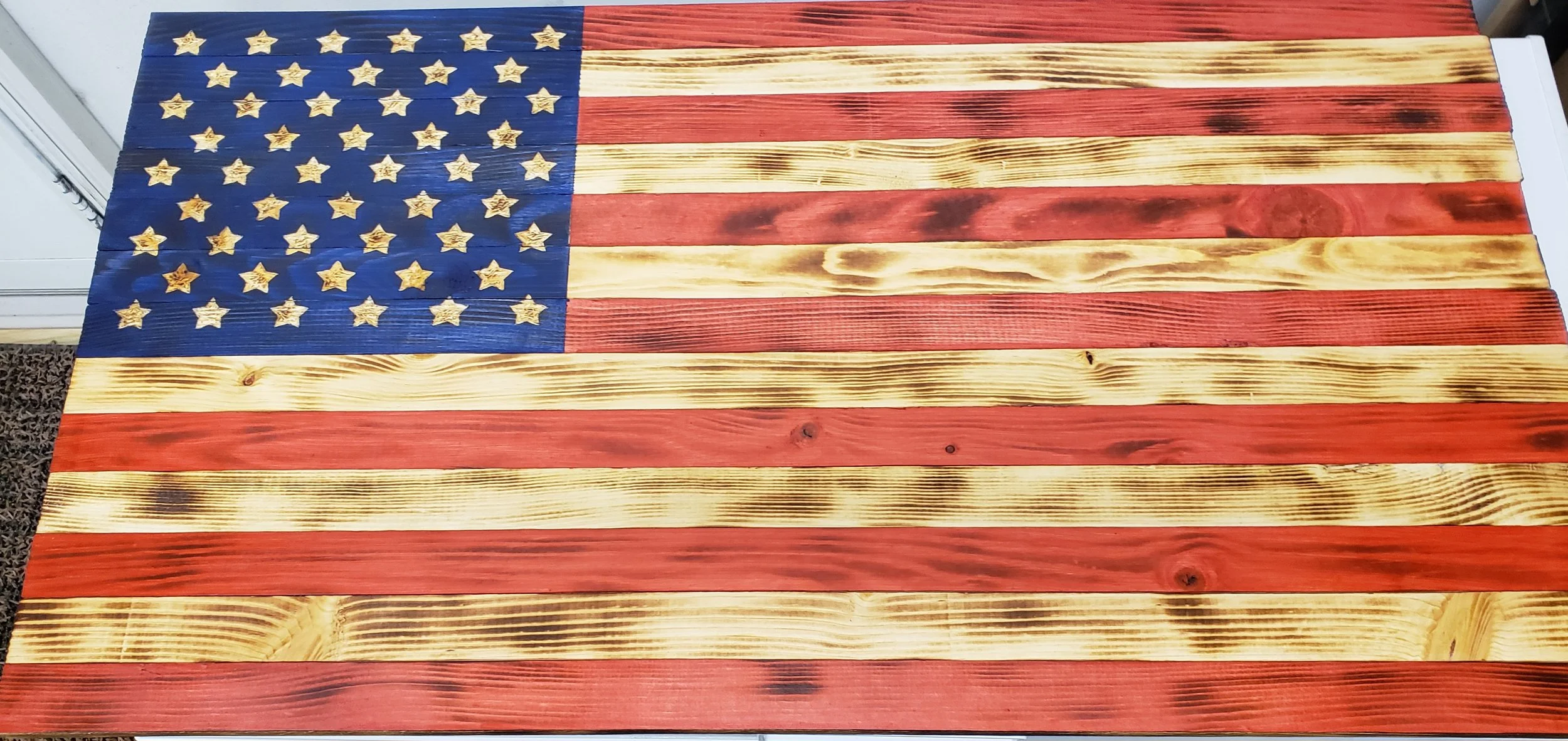 Wooden American flag with a rustic, stained finish