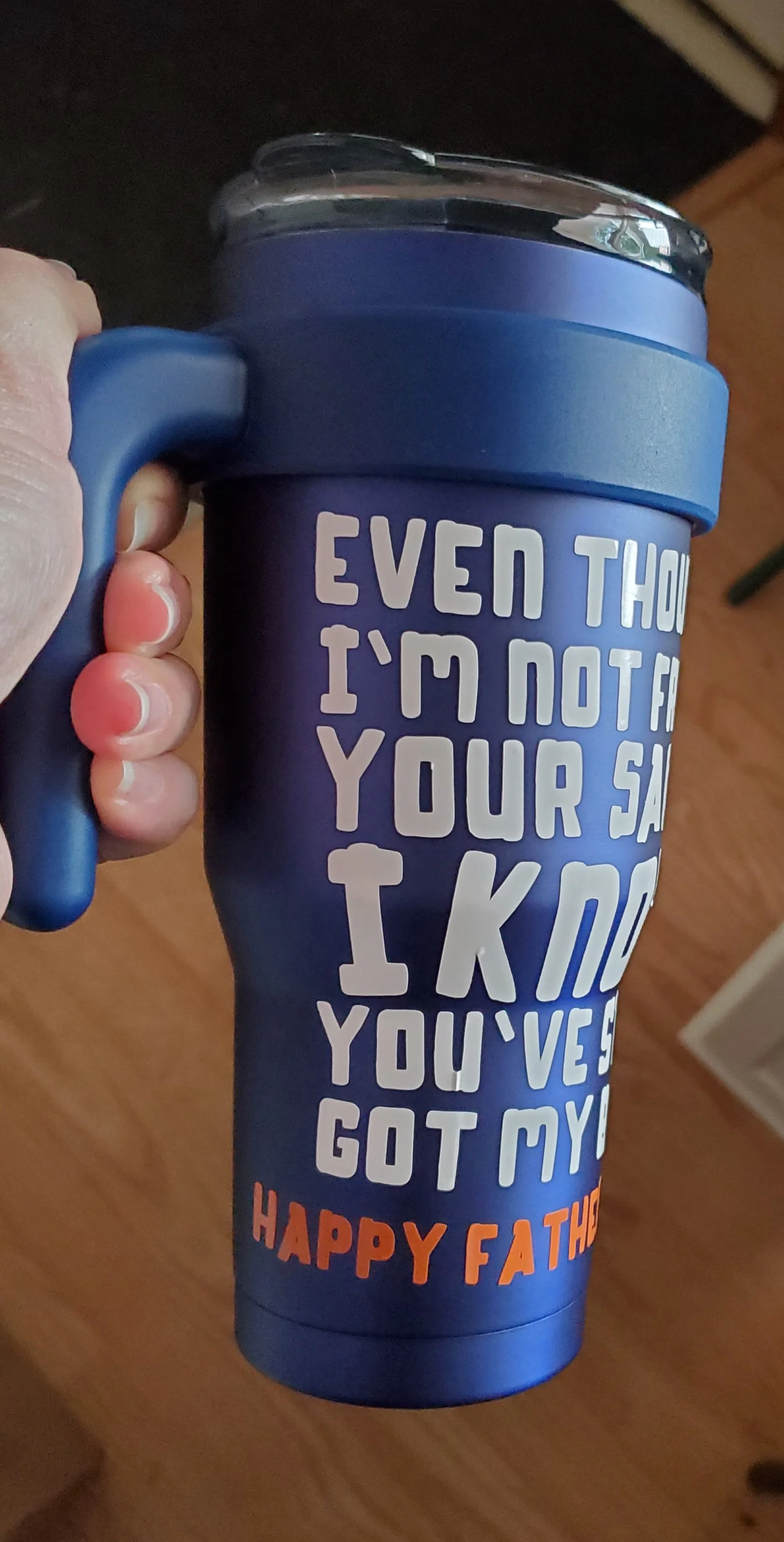Blue travel mug with a lid, featuring a birthday message for Father's Day in white and orange text.