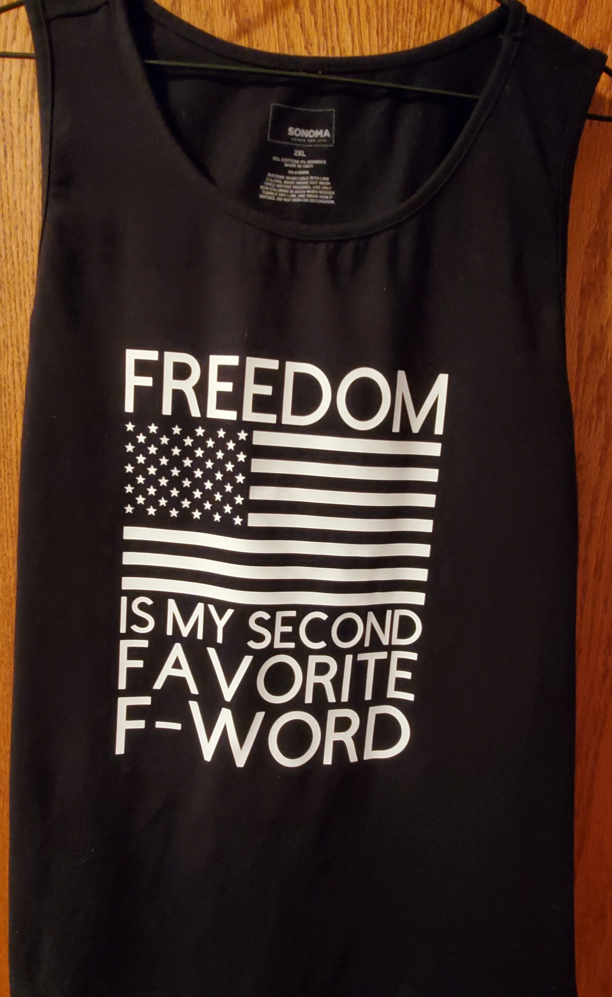 Black sleeveless shirt with white text and an American flag. The text says, 'FREEDOM IS MY SECOND FAVORITE F-WORD.'